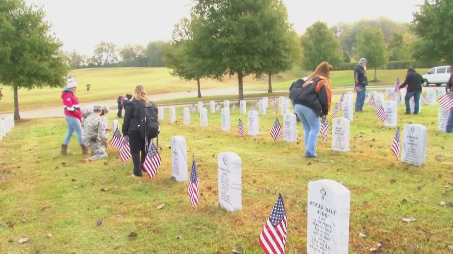 Today, volunteers started placing flags at veterans' gravesites at two East Tennessee cemeteries, ahead of veterans day.