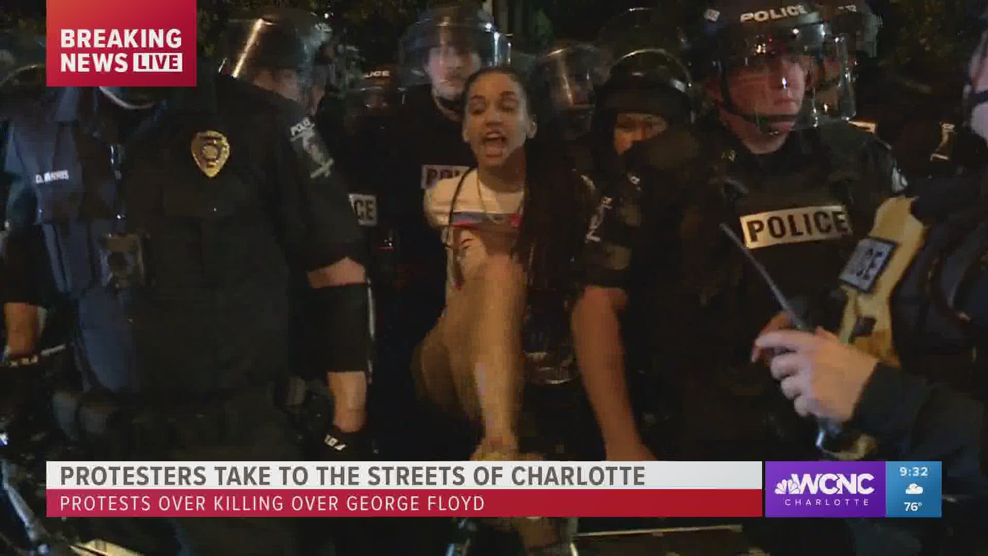 Among protests outside CMPD headquarters, a woman was taken into custody for possession of a conceal weapon, Charlotte Mecklenburg Police Department said.