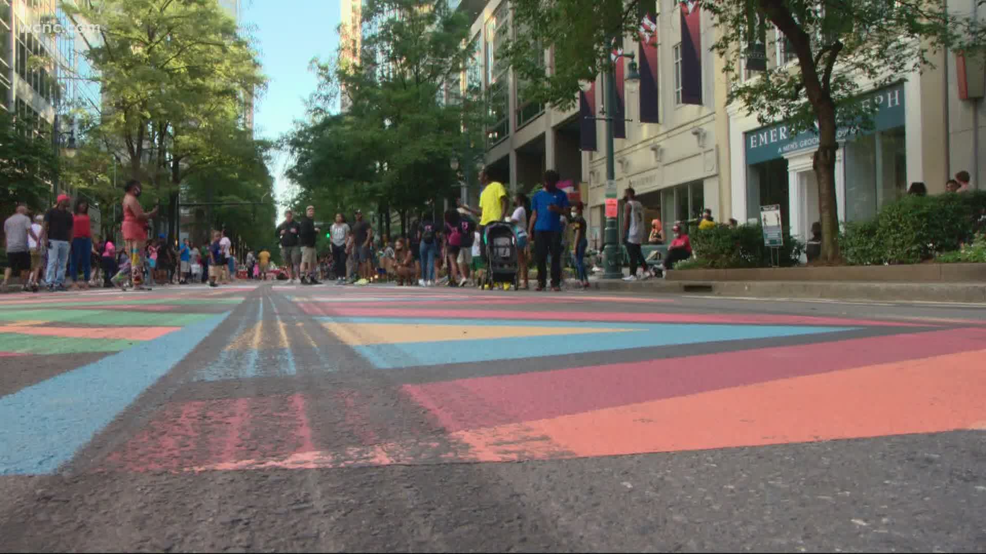 The painting was done Tuesday by a group of local artists. A video taken Friday showed tire marks covering the mural.