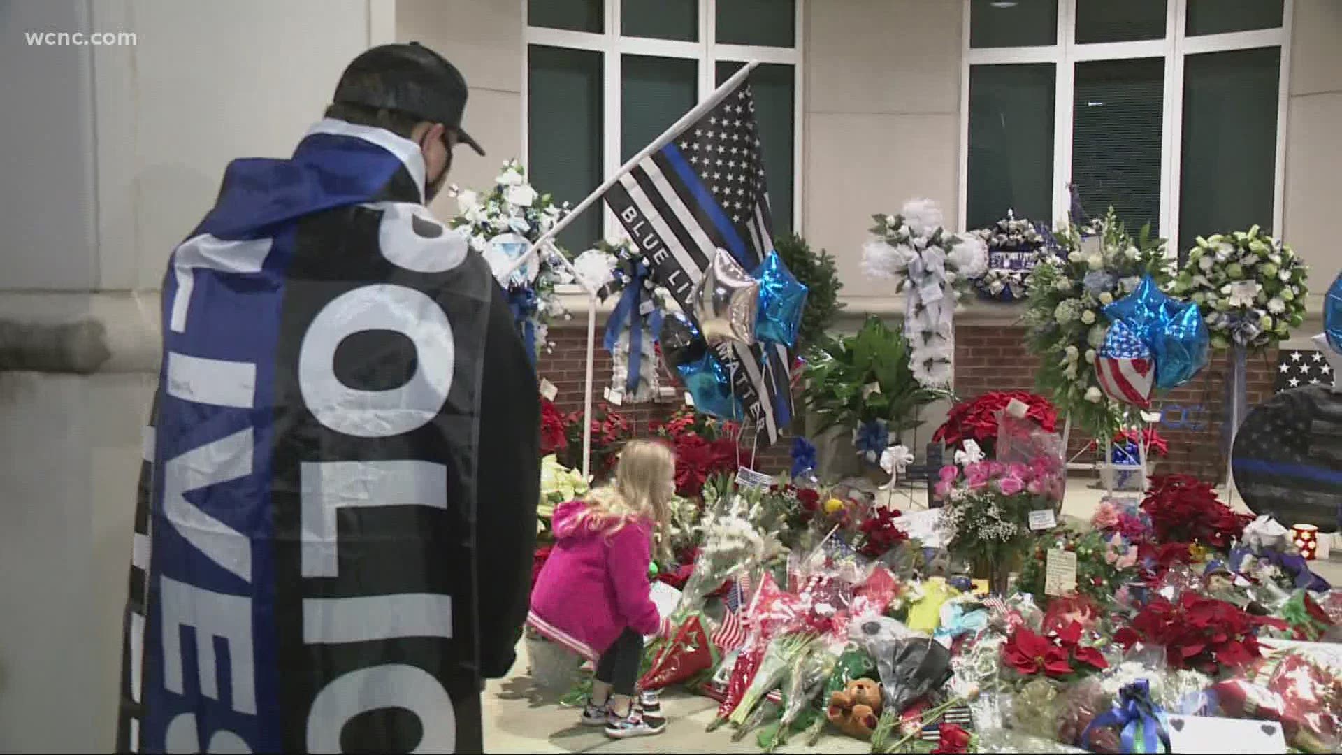 A memorial of flowers, signs and ballons is growing outside the Concord Police Department to remember officer Jason Shuping.