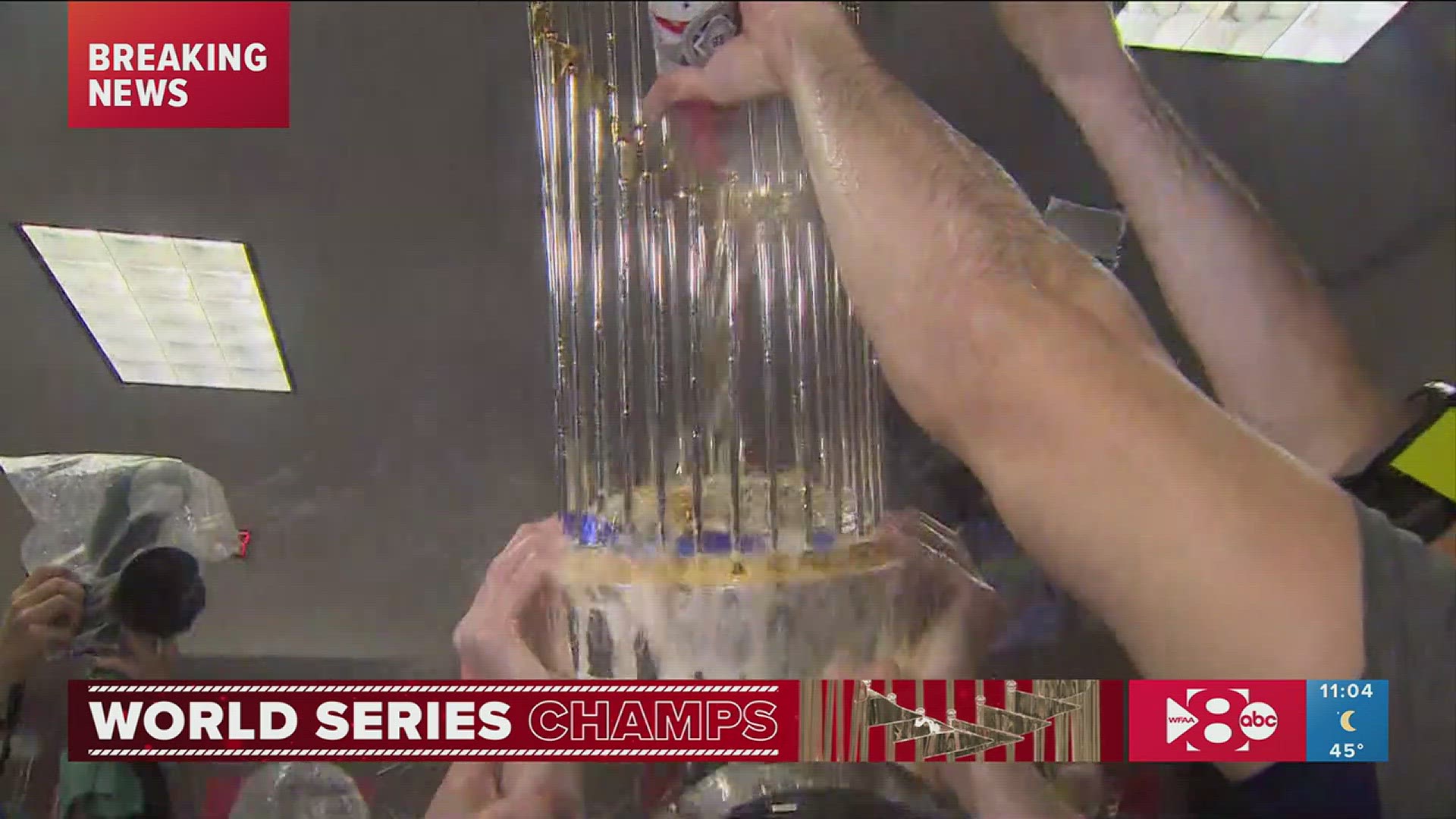 The Texas Rangers gave the Commissioner's Trophy a champagne shower after winning the 2023 World Series.