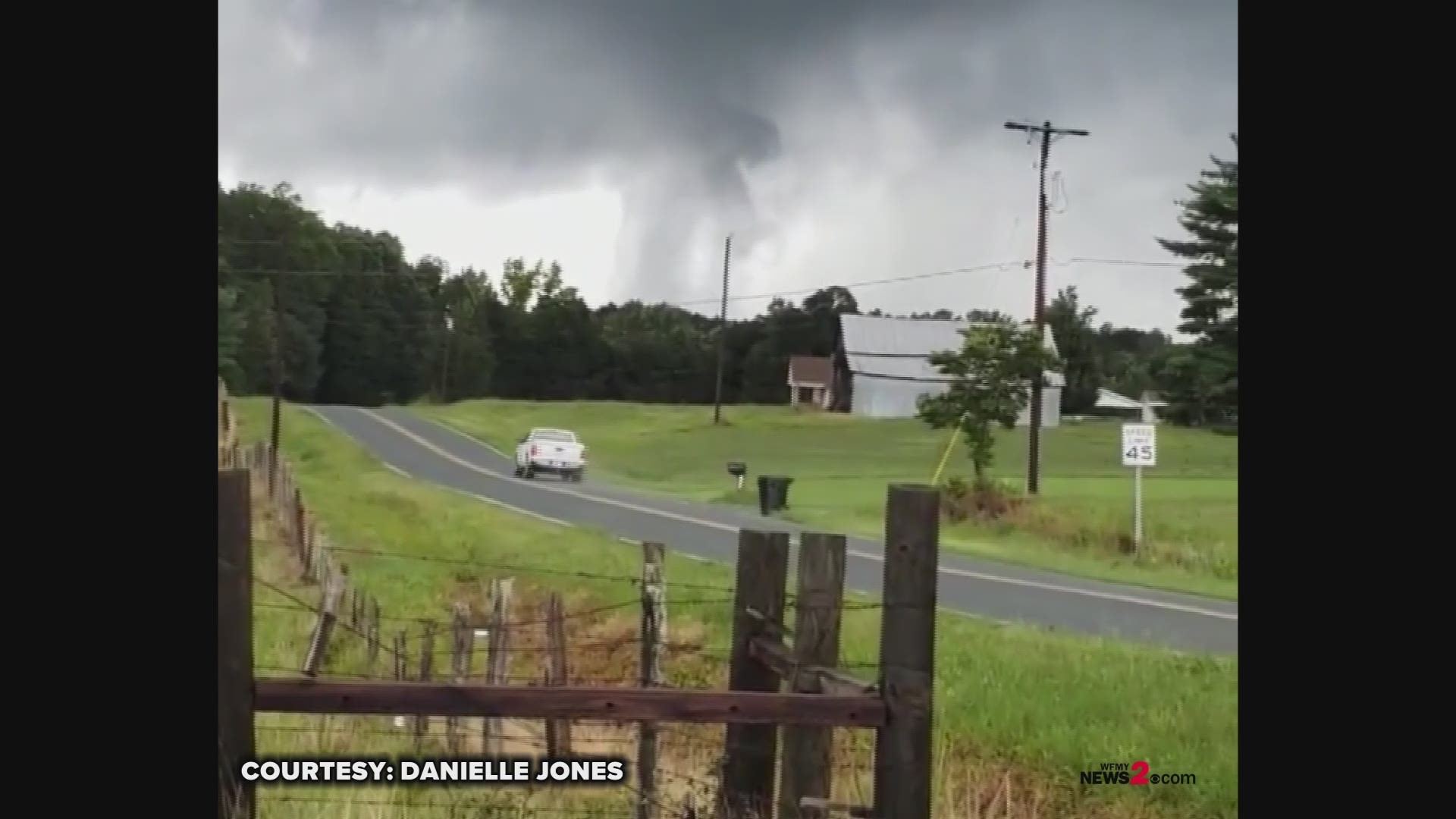 You'll see the cloud spinning very low to the ground. It's hard to tell if it's touching the ground or not. If not touching, it's a funnel cloud. If it is, it's a weak tornado. Video Courtesy: Danielle Jones
