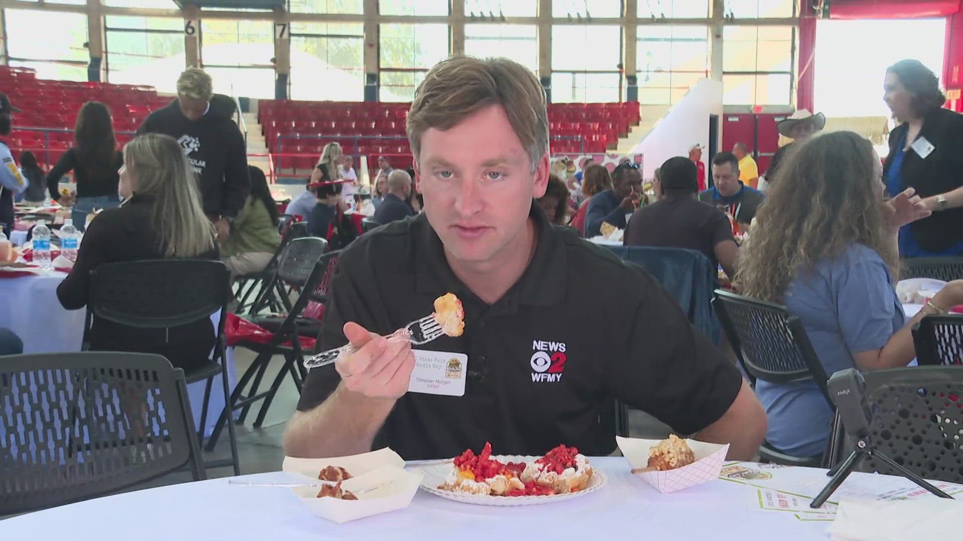 WFMY News 2's Christian Morgan tries the GoldenKDog’s “Honey Butter Mozza Dog” at the North Carolina State Fair.