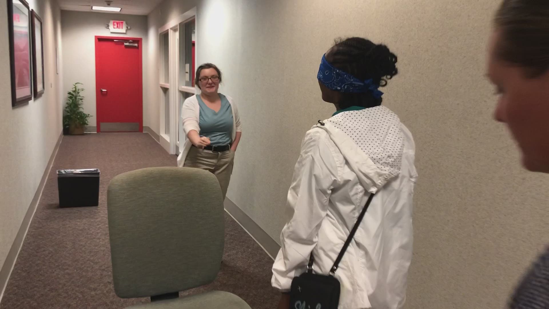 Amber helps her classmate navigate a hallway blindfolded as a part of a communications exercise at Project SEARCH
