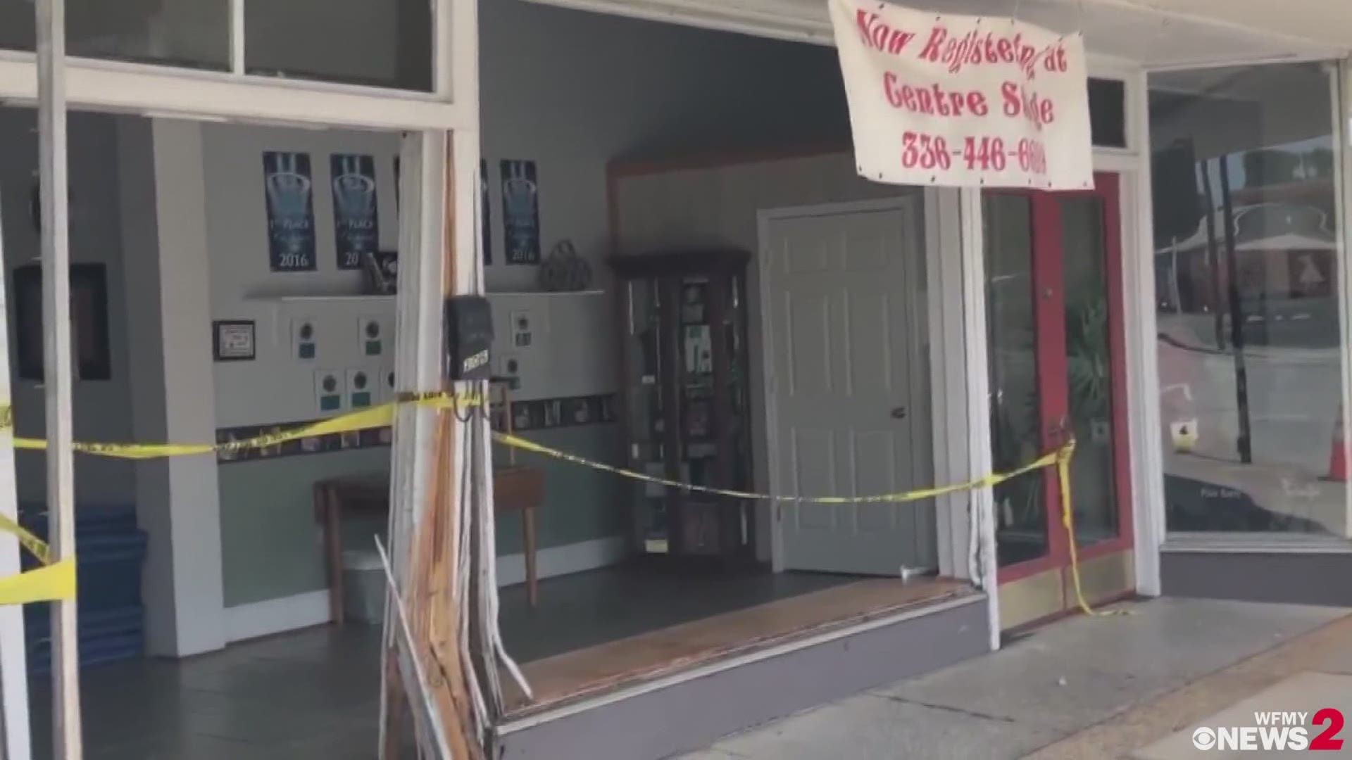 The front windows of a Gibsonville dance studio were knocked out after a crash involving a police car Wednesday morning.