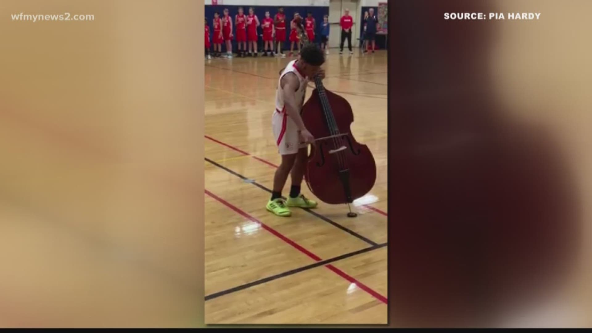 An 8th grade Clemmons Middle School basketball player shocks a crowded gym with his bass-playing abilities.