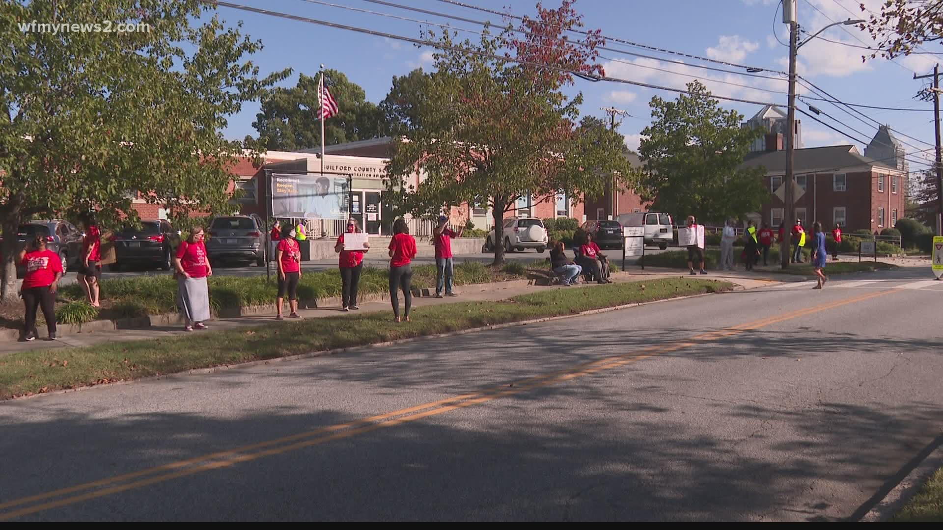 The Guilford County Association of Educators rallied for safer reentry outside of the meeting
