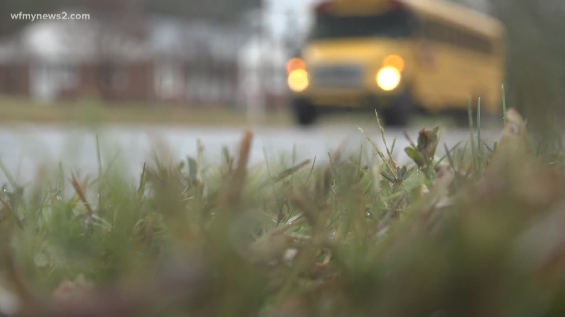 You can see two students sitting on the ground in the overcrowded Guilford County Schools bus.