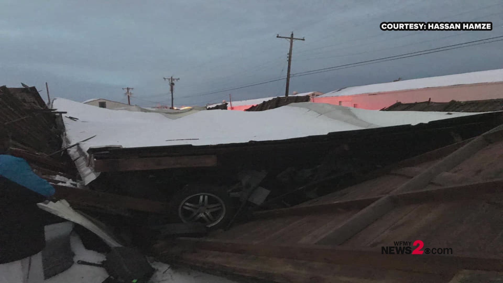 Heavy snow was just too much for a warehouse in Greensboro as it buckled and crushed the cars below.