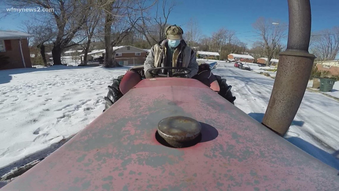A Greensboro man uses his tractor to clear the roads