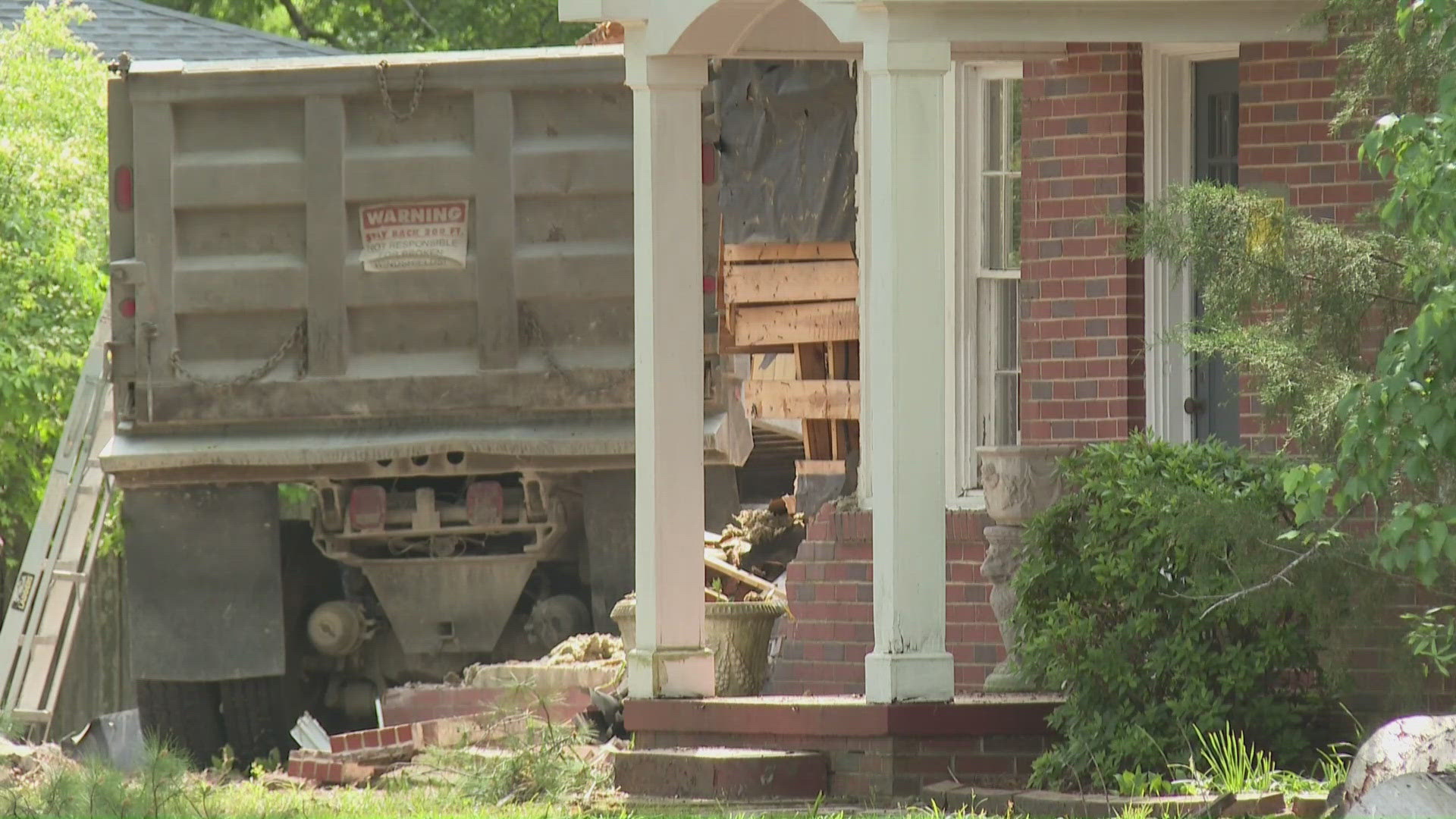 Dump truck crashes into home on Vandalia Road in Greensboro, injuring ...