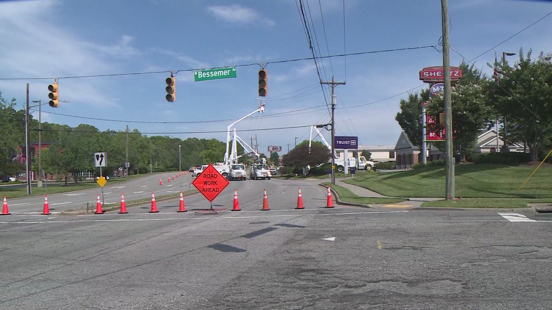 Crews worked along Battleground Avenue to fix the utility poles Tuesday.