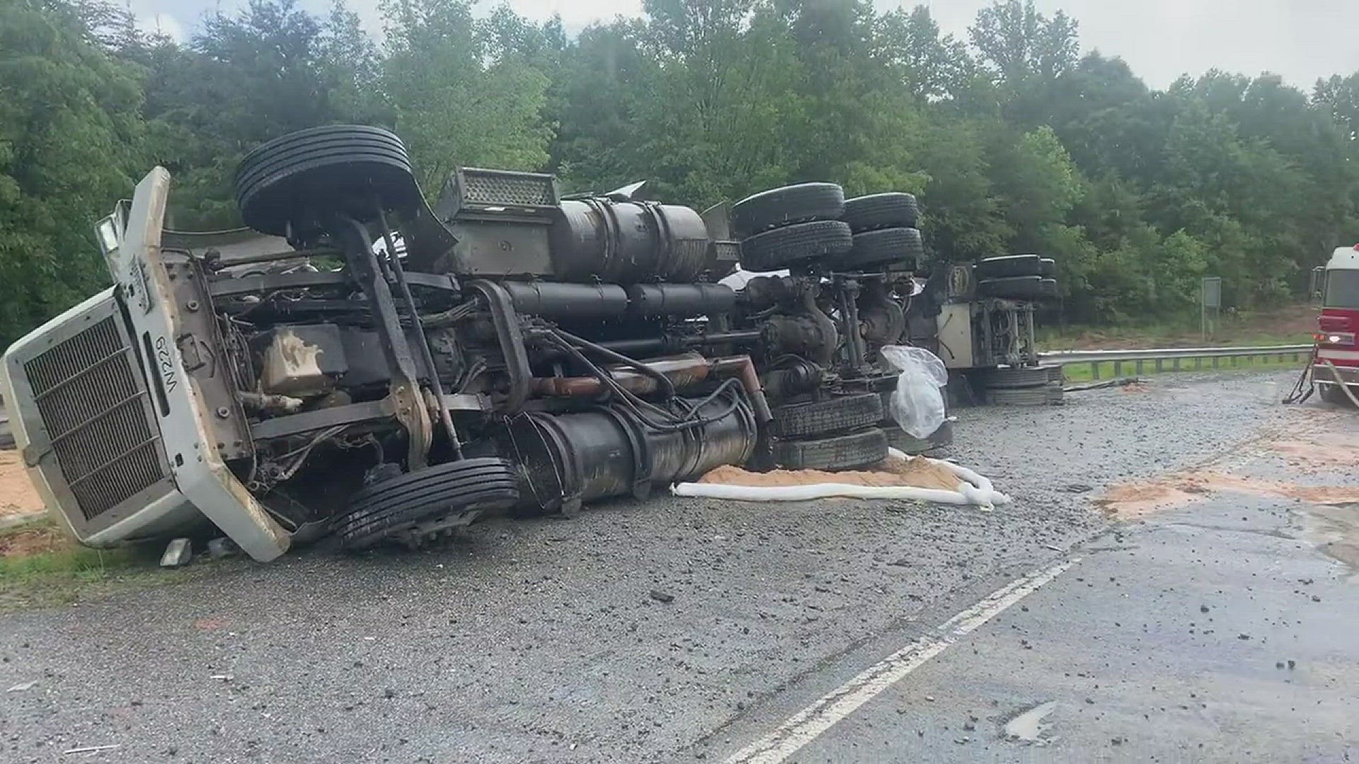 Winston-Salem fire crews are at the scene of an overturned tractor trailer with a gas spill in the road causing road closures