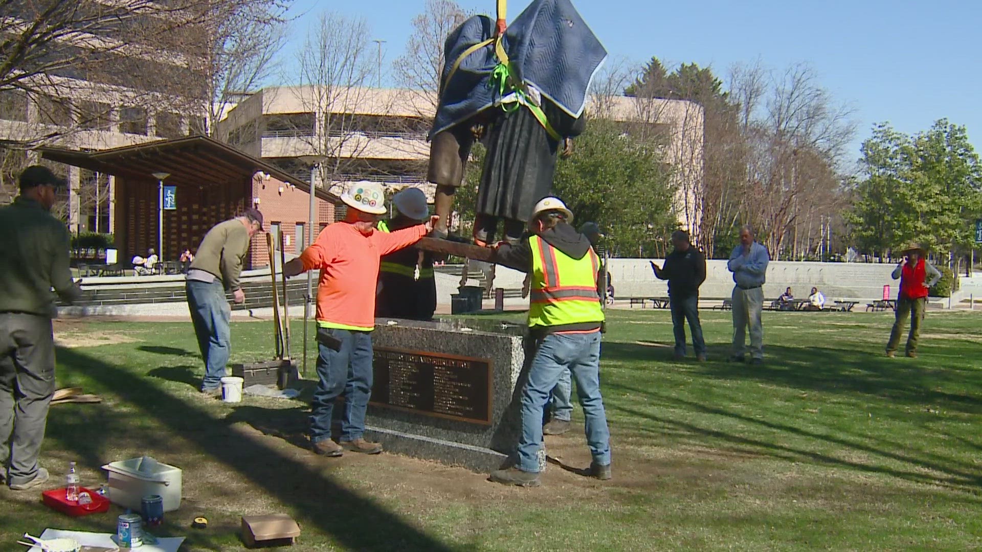 A statue honoring former Chief Justice Henry Frye and his wife Shirley arrives downtown.