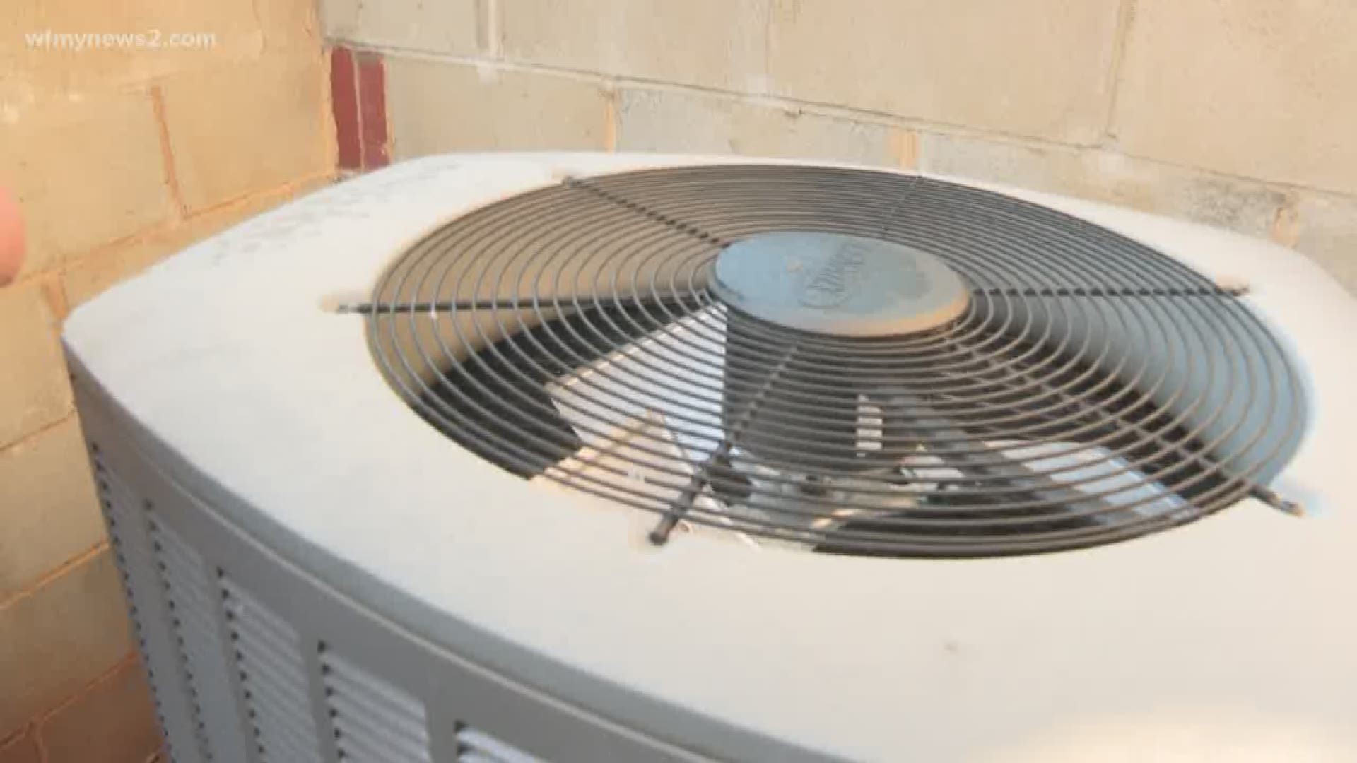You ask; we VERIFY. Yes, you should hose down your AC unit…but not to cool down the unit, itself.