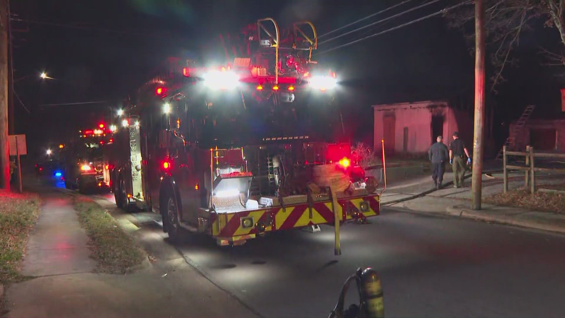 Two small outbuildings were on fire behind a Thomasville home, one person was detained for questioning, police say.