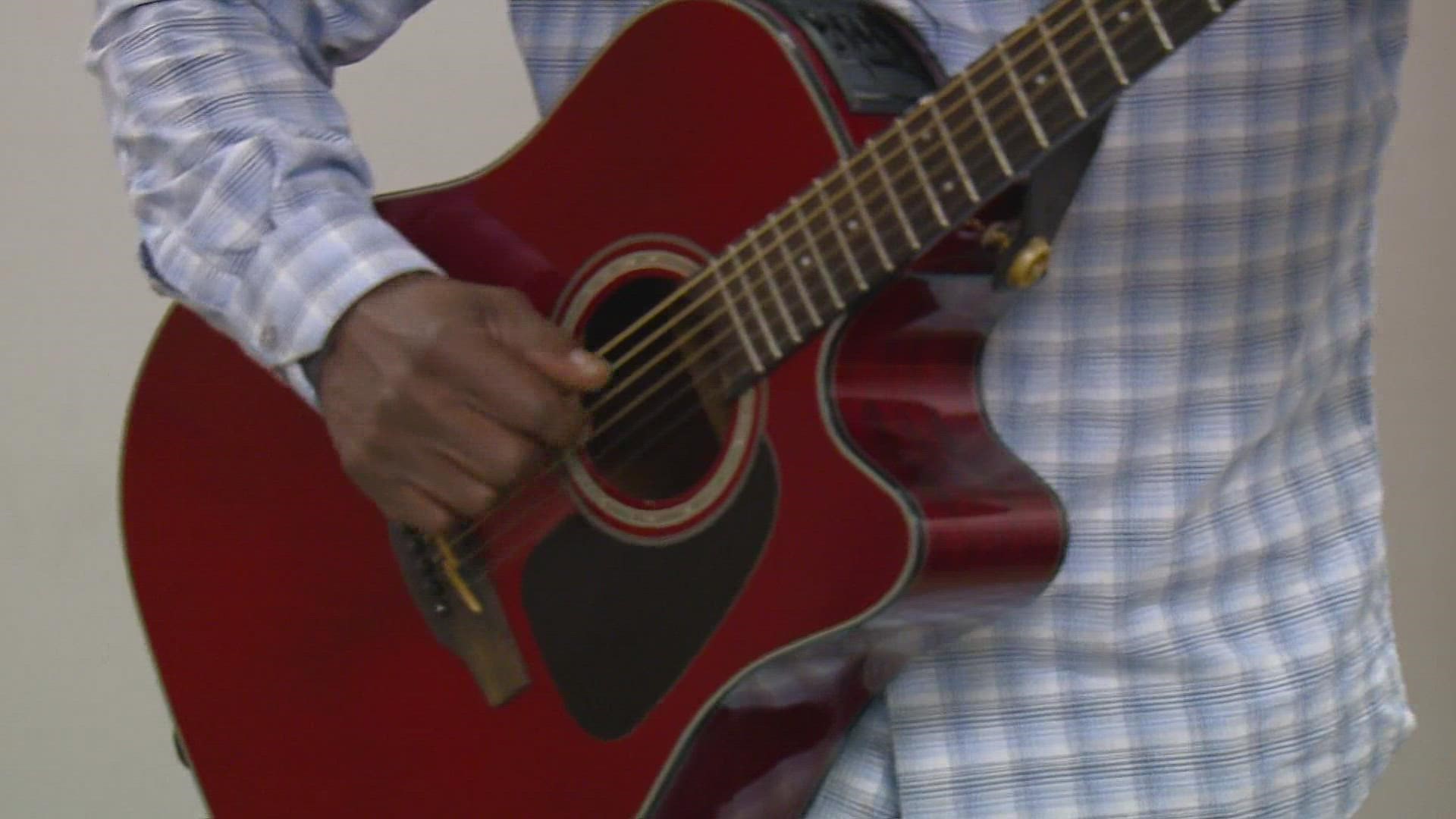 Take a walk through downtown Greensboro and you could hear the strum of George Achini's guitar.