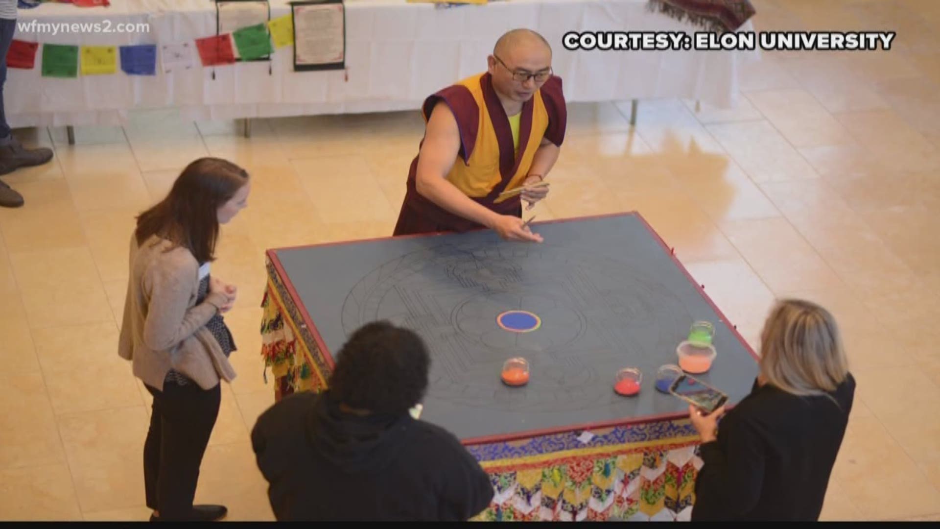 The ancient Buddhist art takes a while. Students gathered over the last few days to watch him work.