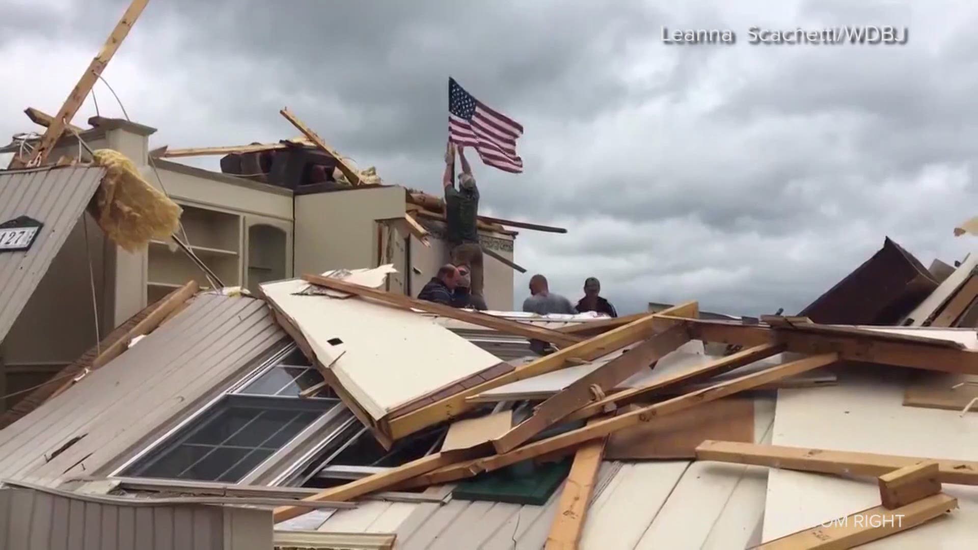 An American flag flies over a home in Franklin County, Va. after a tornado touched down in the area.