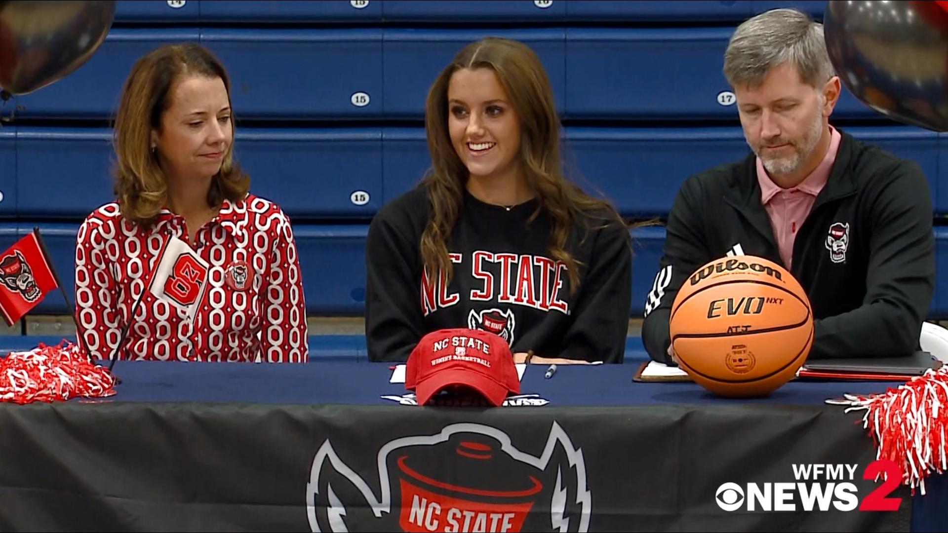 Bishop McGuinness guard Adelaide Jernigan signs her national letter of intent for the North Carolina State women's basketball team.