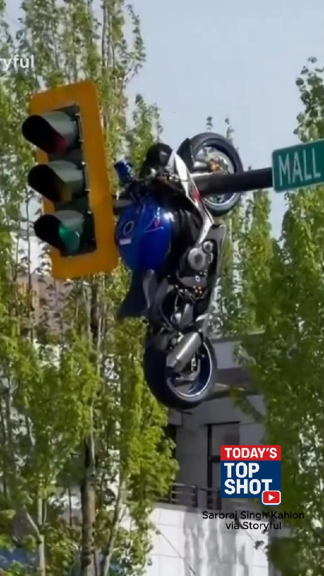 Motorcycle hangs from traffic light after crash | wfmynews2.com