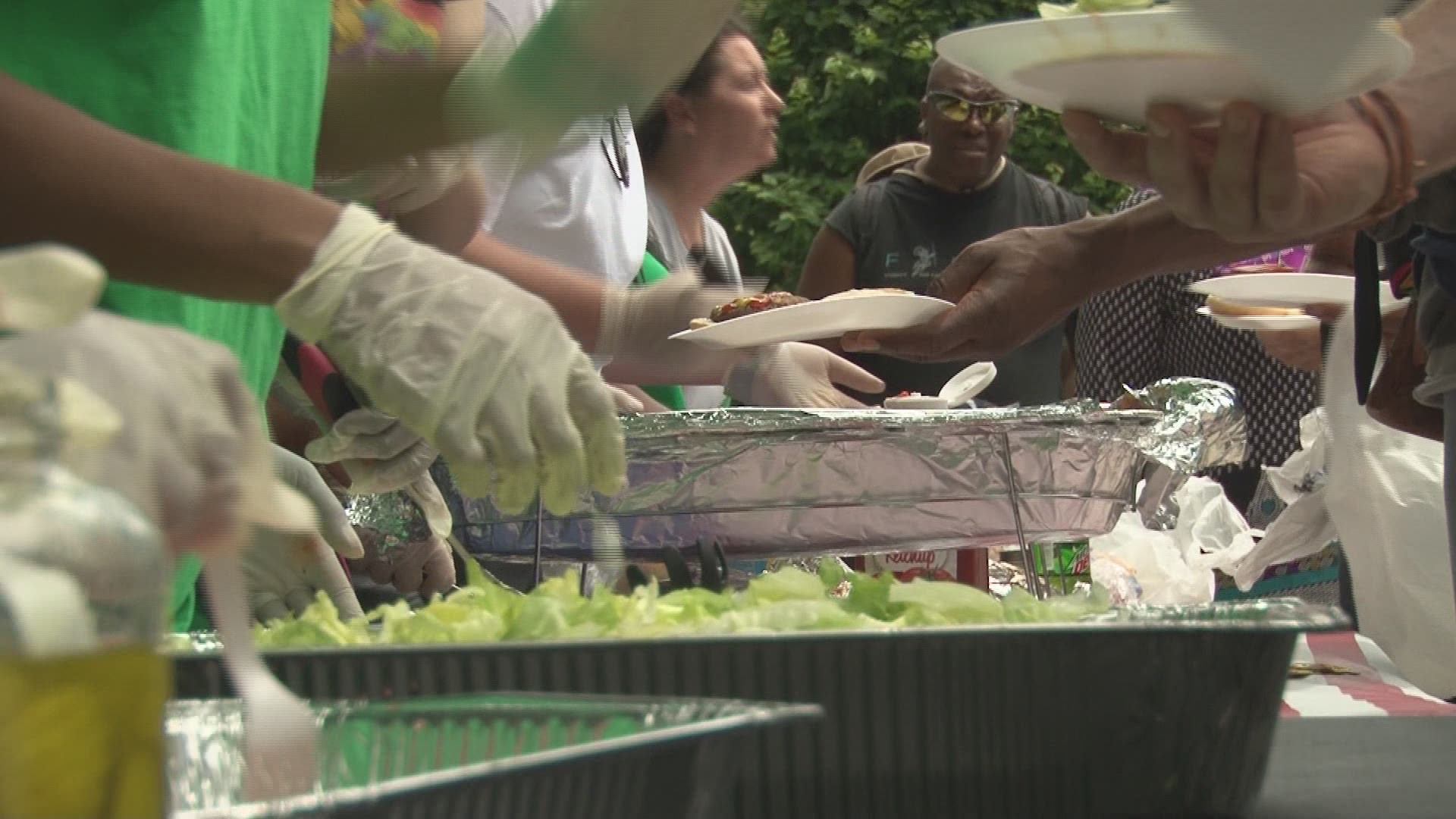 The Helping Hands 'Green Team' feeds homeless veterans for Memorial Day during a cookout.