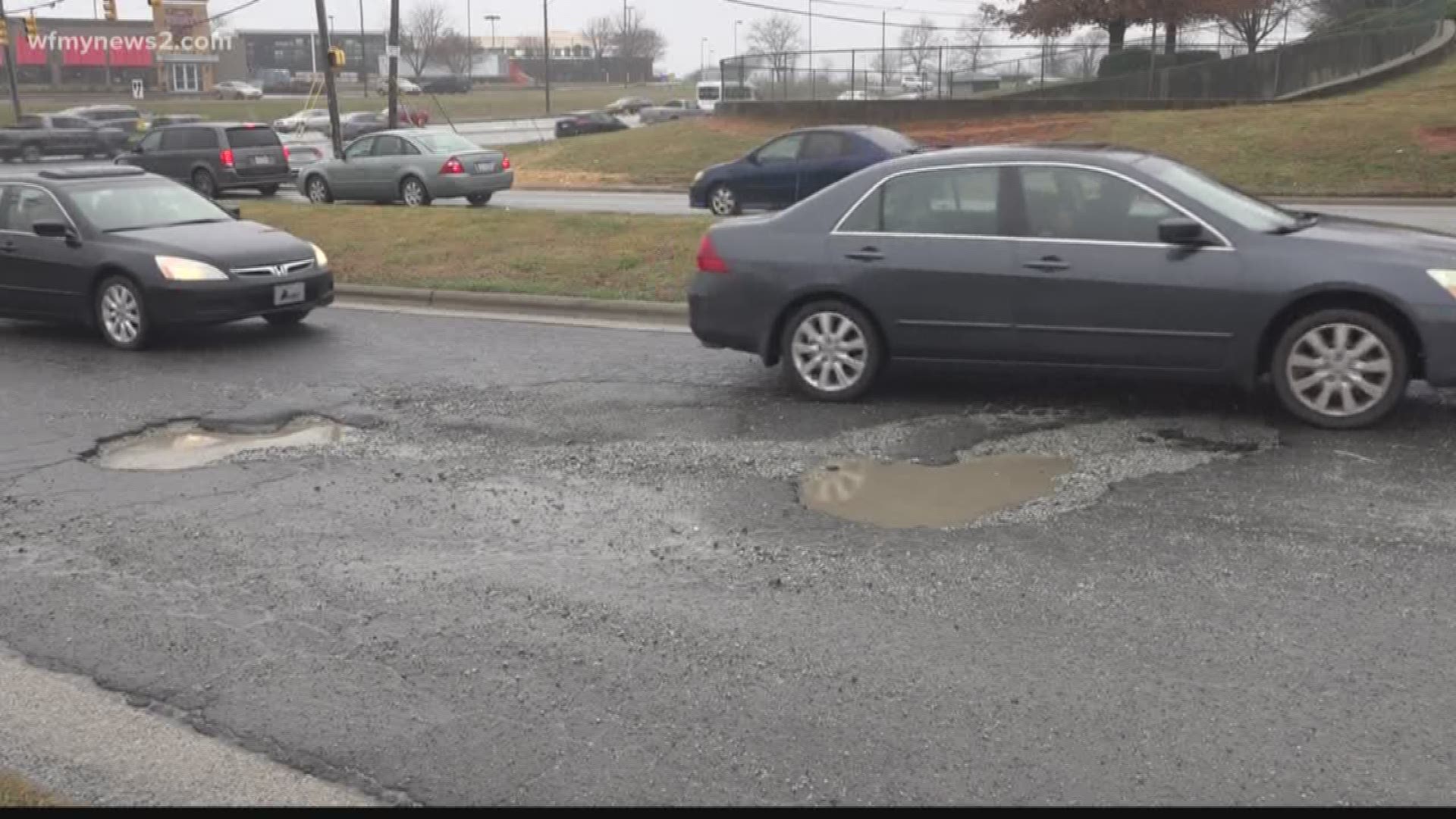 These potholes are on Landview Drive heading into Sam's Club off Wendover Avenue and this isn't the first time we've seen a pothole problem in the area.