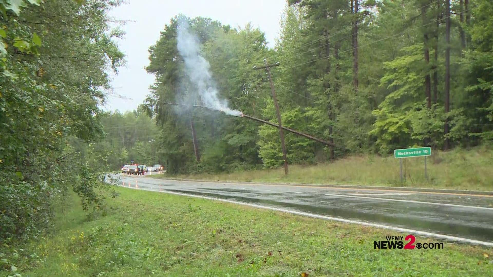 Tree falls on power line and catches on fire outside of Mocksville