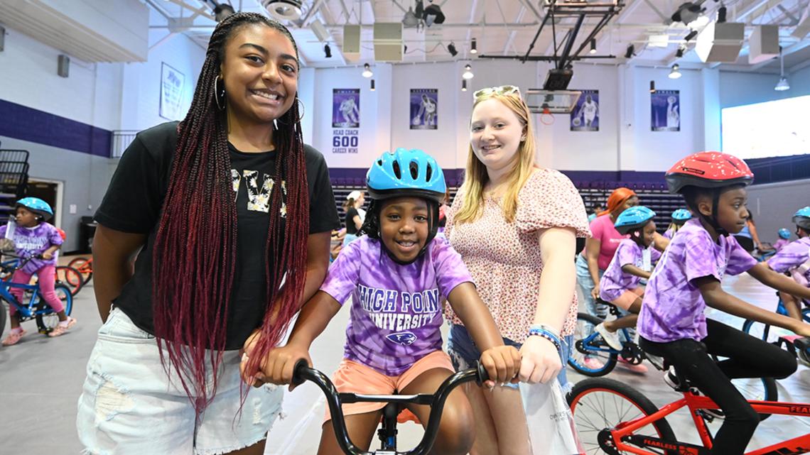 High Point University freshmen surprise local kids with 150 new bikes