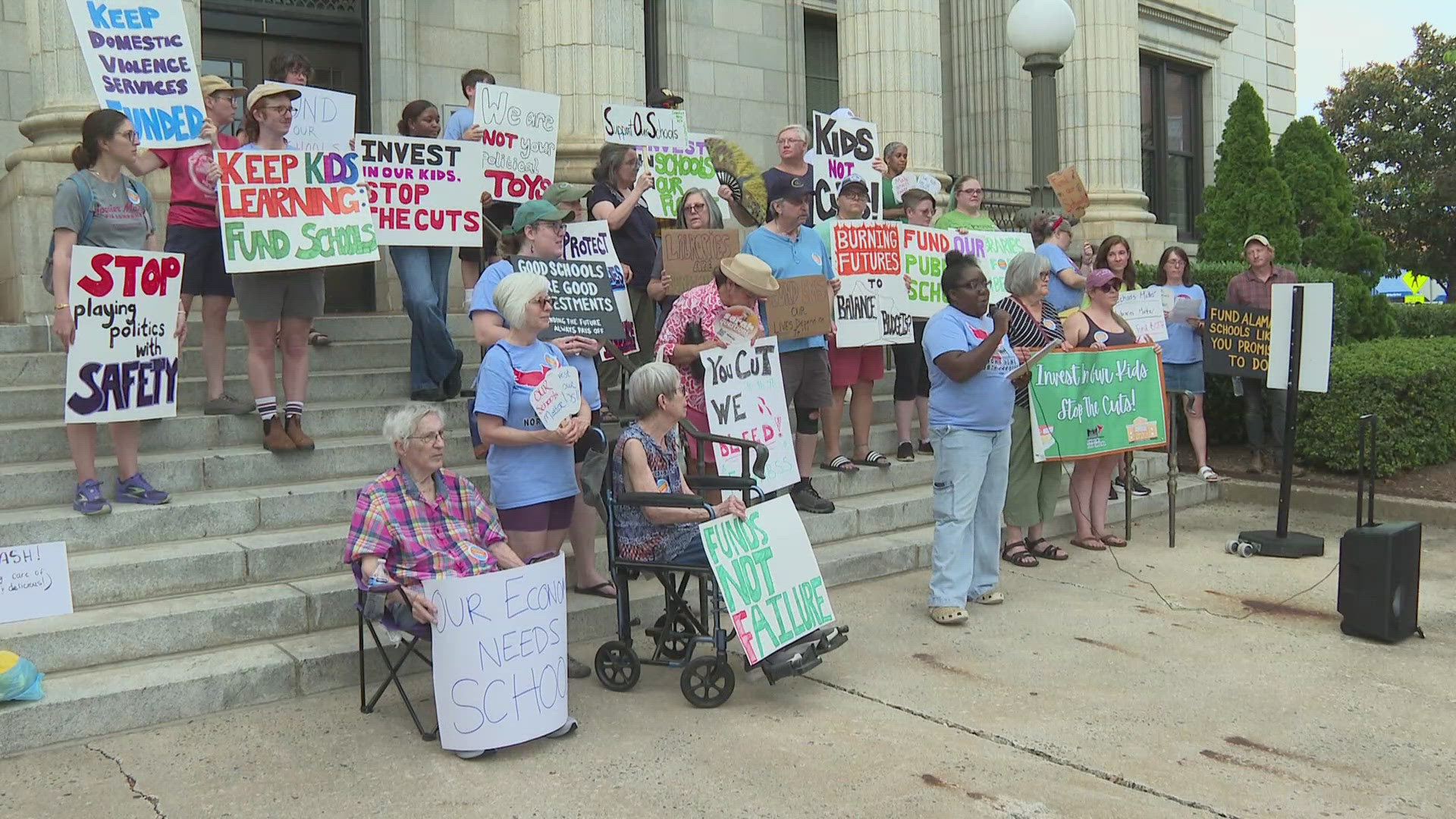 Dozens of people gathered outside the courthouse, trying to get county commissioners to make a change to the proposed budget.