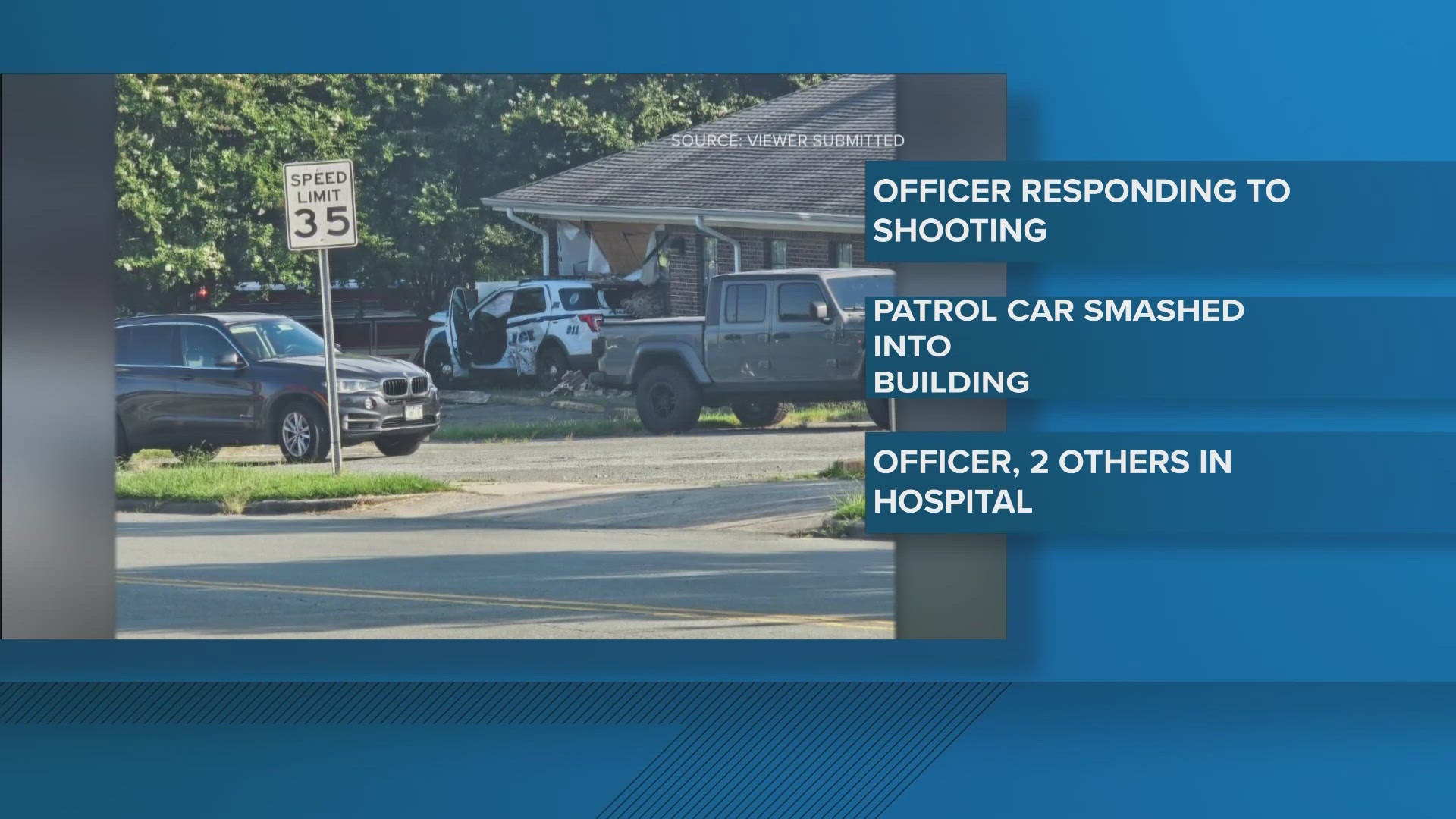 A Burlington police officer and two others were injured when a patrol car responding to a shooting collided with another vehicle and hit a building.