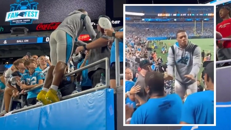 Carolina Panthers wide receiver DJ Moore leaps into the stands to break up  a fight between fans