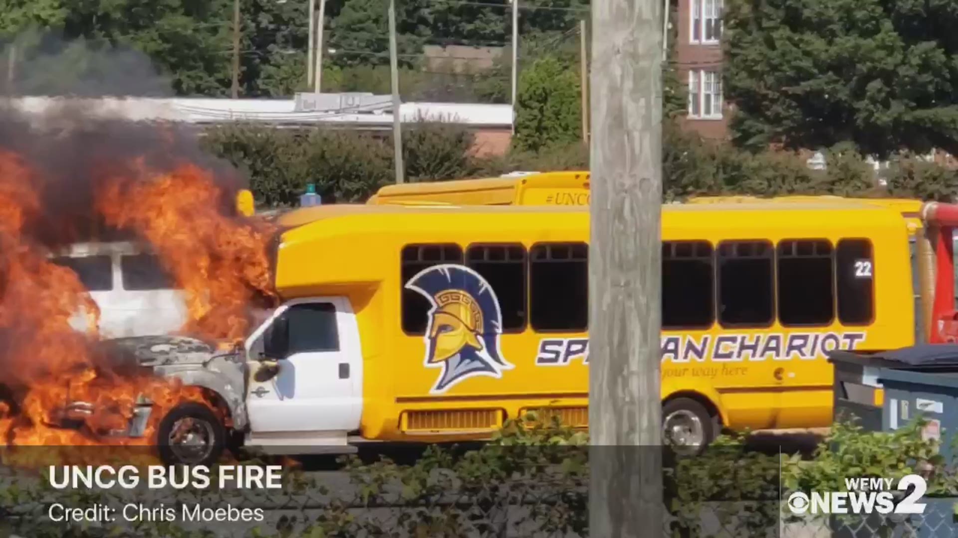 Flames and smoke showing from a UNCG bus. Greensboro Fire officials said the fire occurred after an engine light came on. Courtesy: Chris Moebes