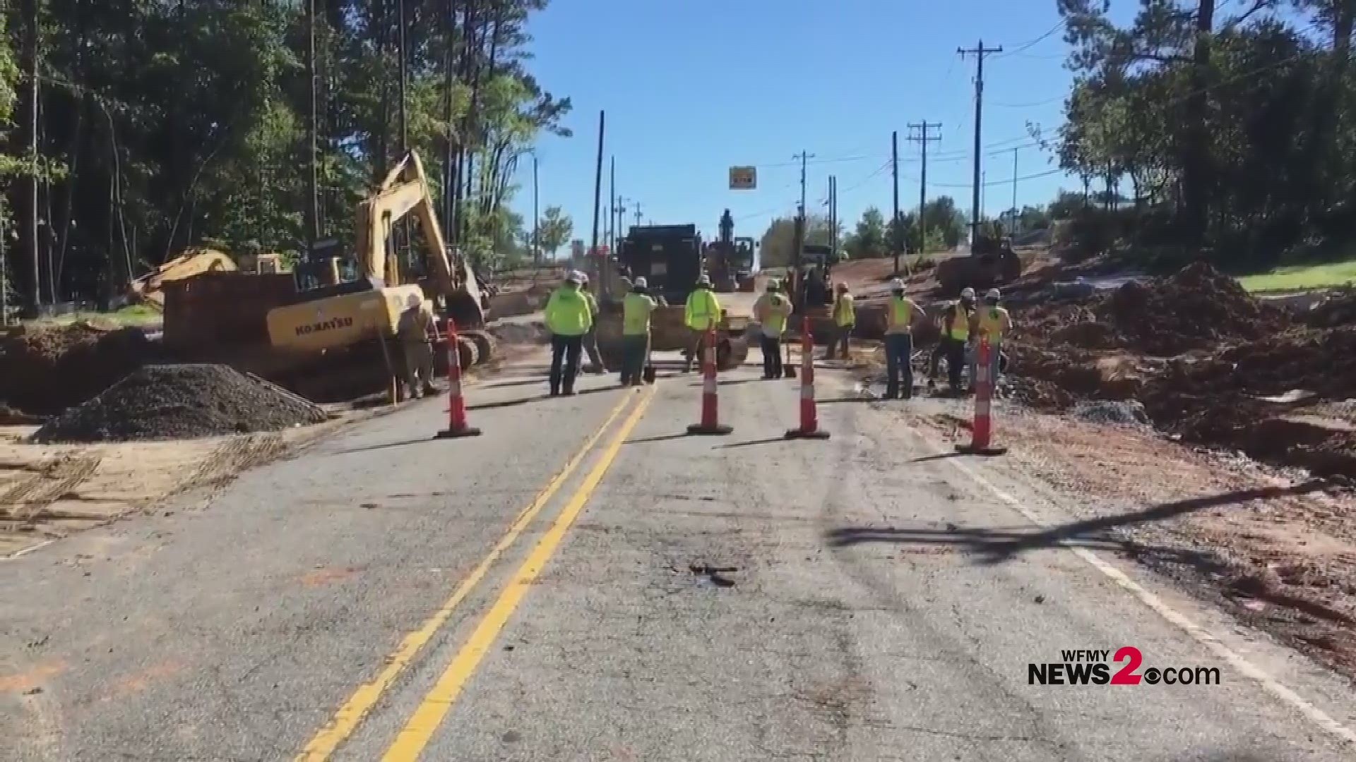 Construction crews repair Horse Pen Creek Road in Greensboro after it was washed out due to flooding from Michael