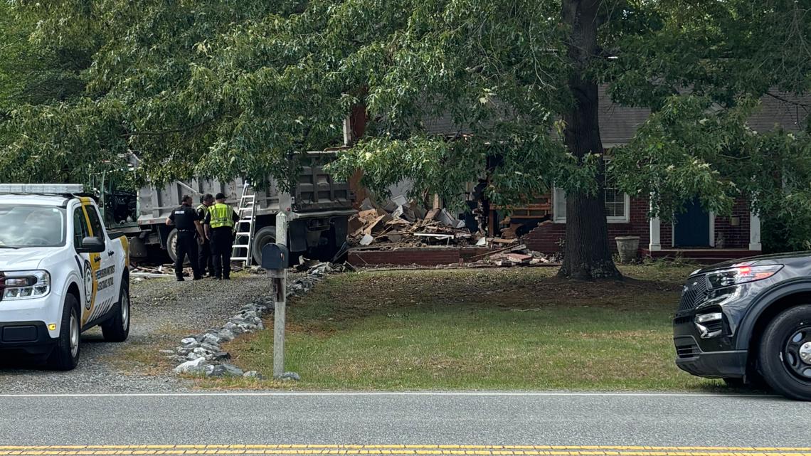 Dump truck crashes into Greensboro home, injuring two