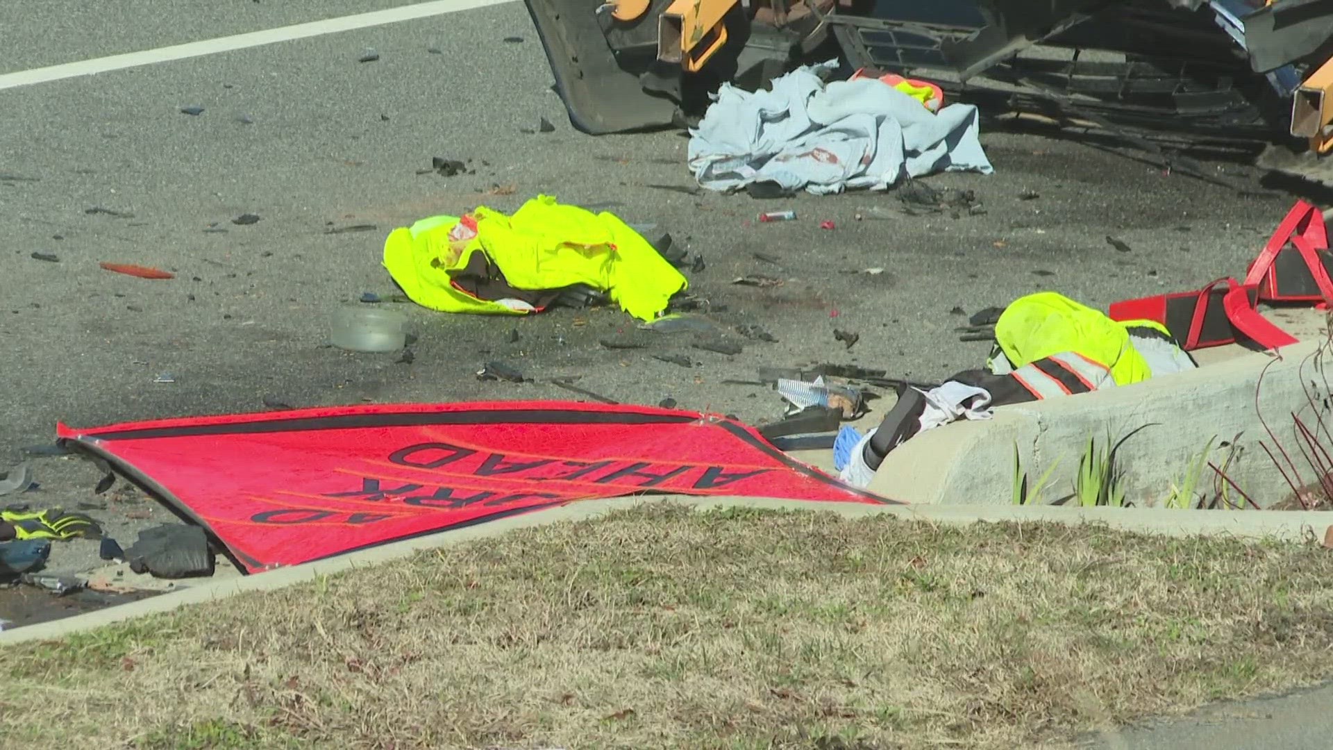 Two workers were attempting to deploy lane closure signs in the right lane of North Murrow Blvd.