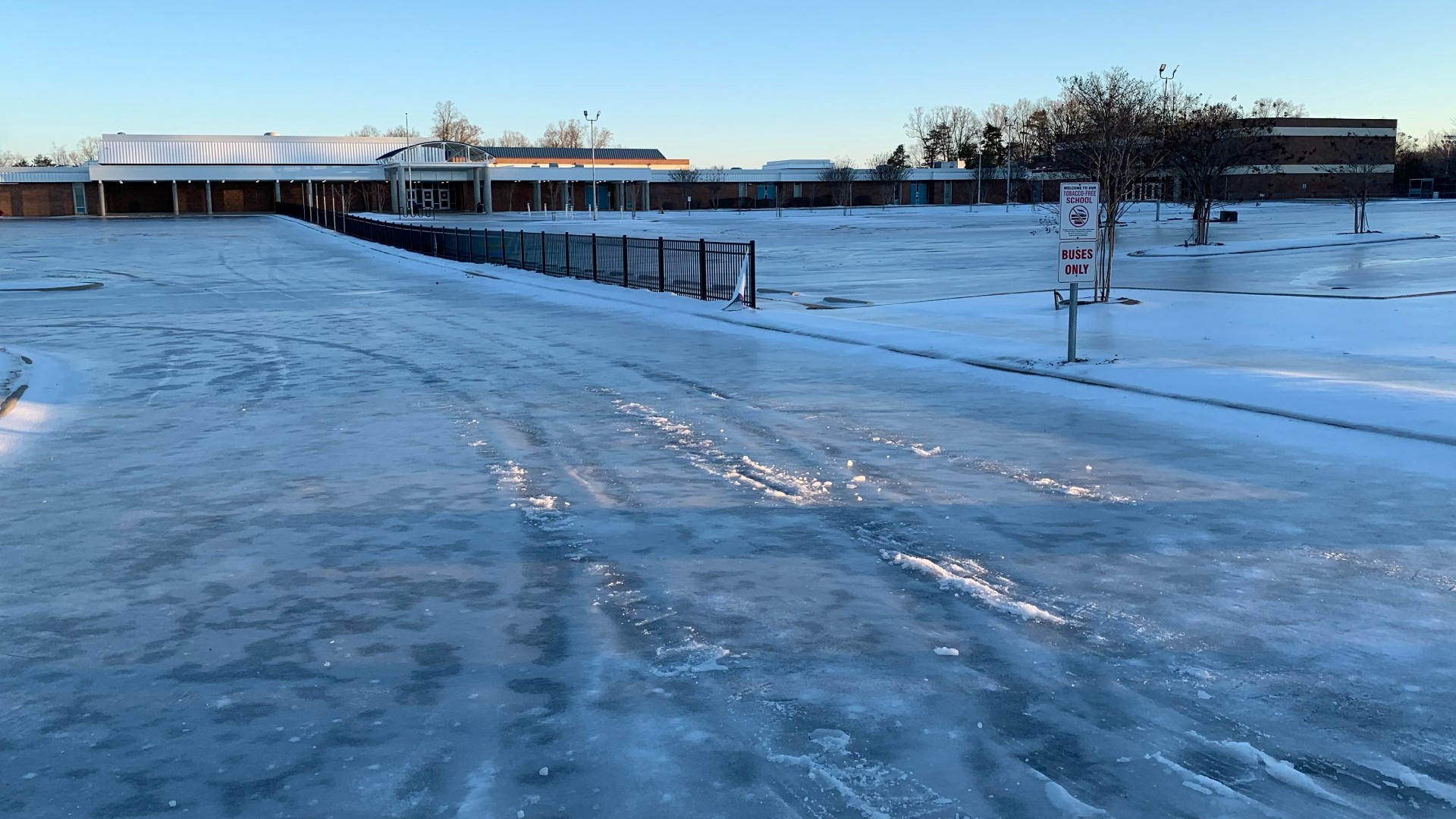 Parkland High School's parking lots remain a solid sheet of ice two days after a winter storm dumped snow, sleet and freezing rain on the Triad.