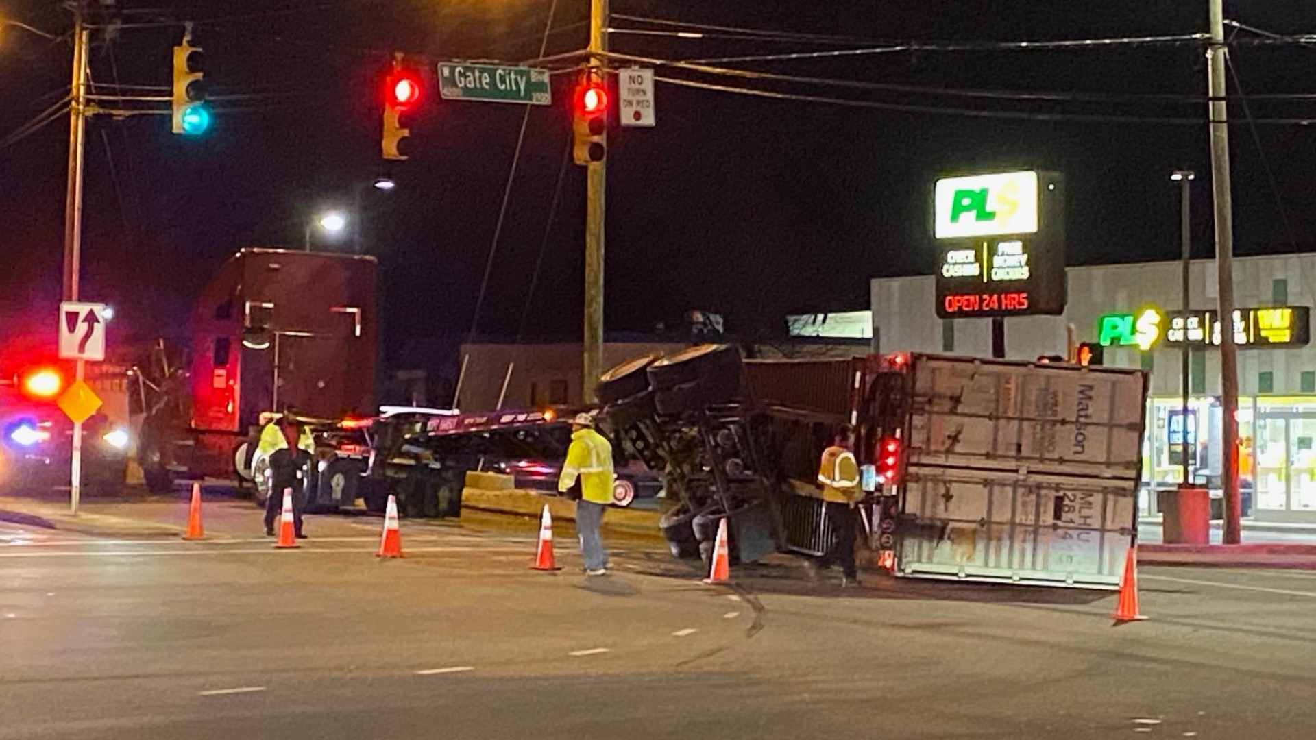 A tractor-trailer flipped over on its side, causing road closures on Gate City Boulevard in Greensboro, police say.