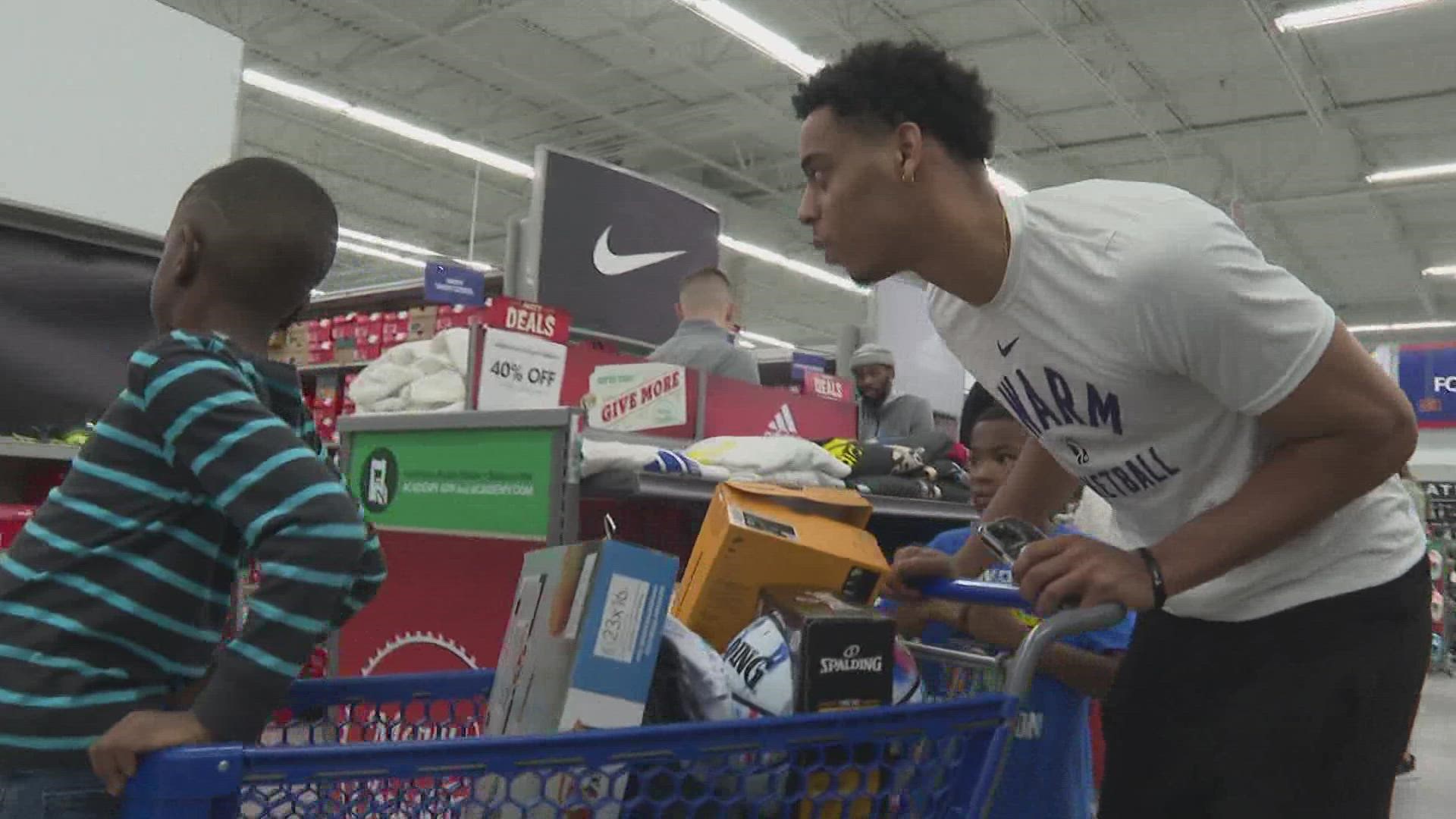 Swam players walked around the store with the children to pick out what they wanted.