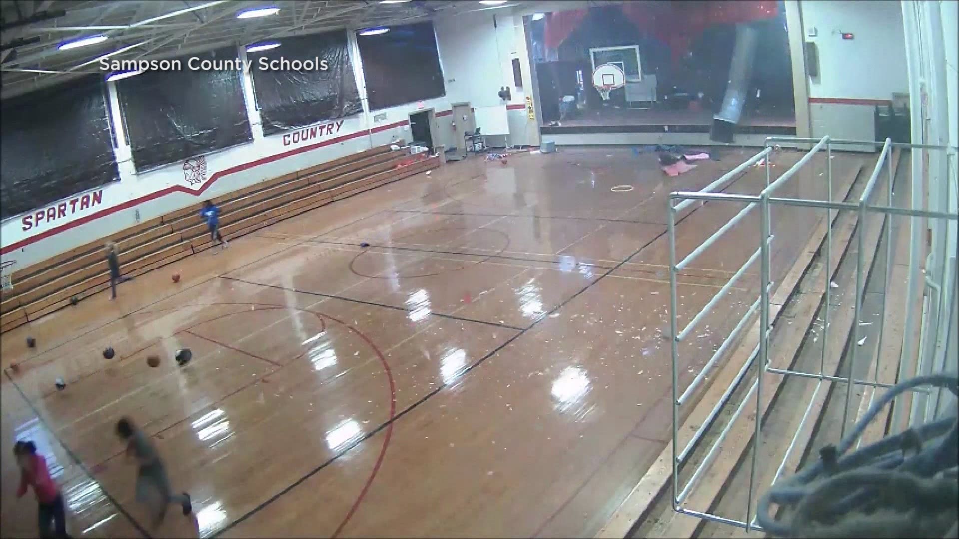 Video from inside a Sampson County school in NC shows children running as a microburst tears part of the gym’s roof.