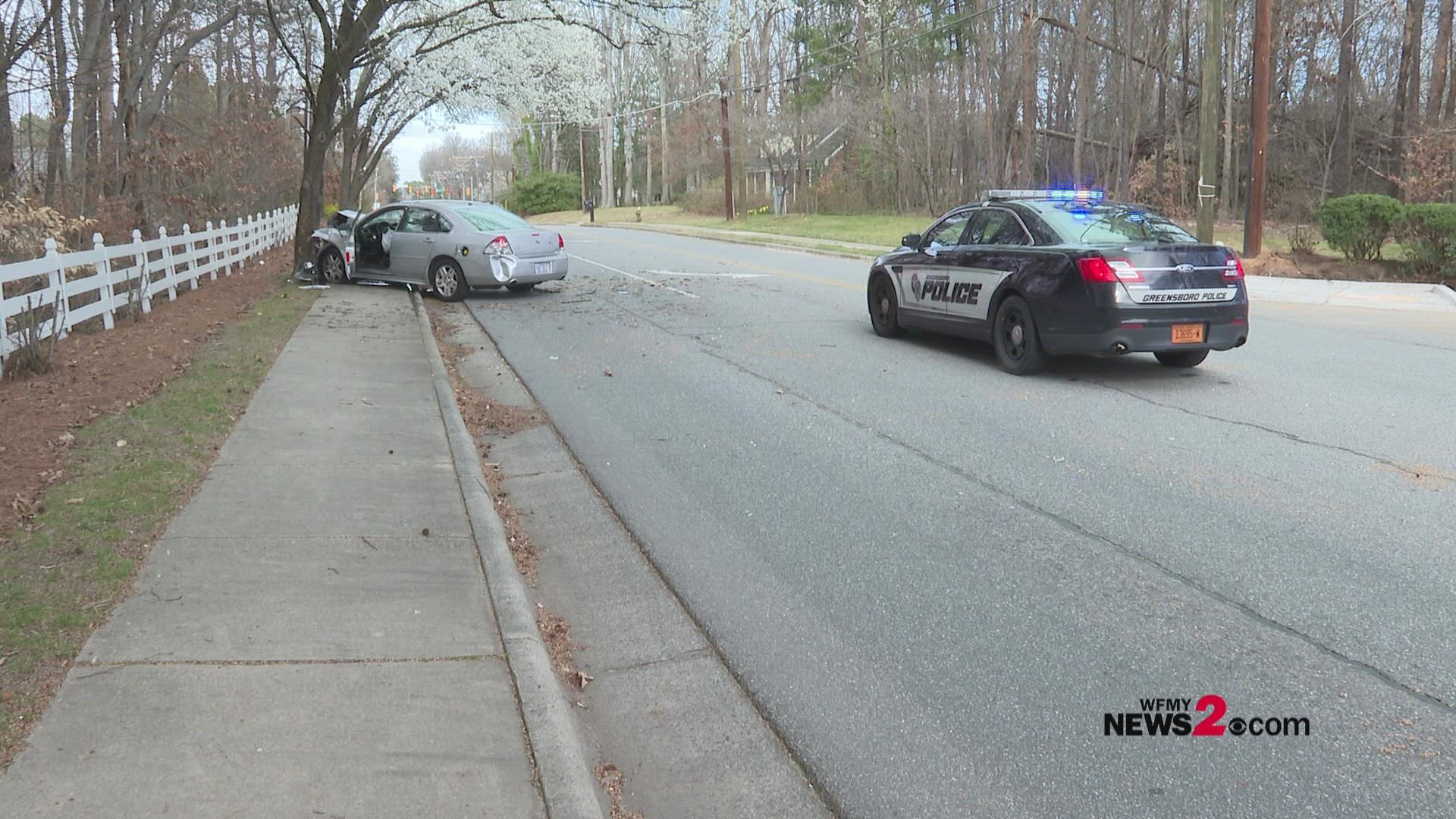 A car ran into a tree in a Greensboro neighborhood Friday, causing slight traffic delays.