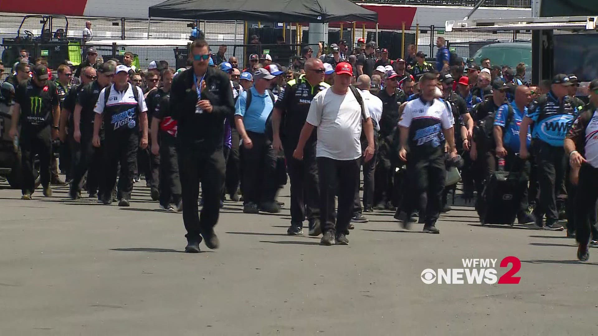 NASCAR crews head to their haulers ahead of the opening of the Garage at North Wilkesboro Speedway.