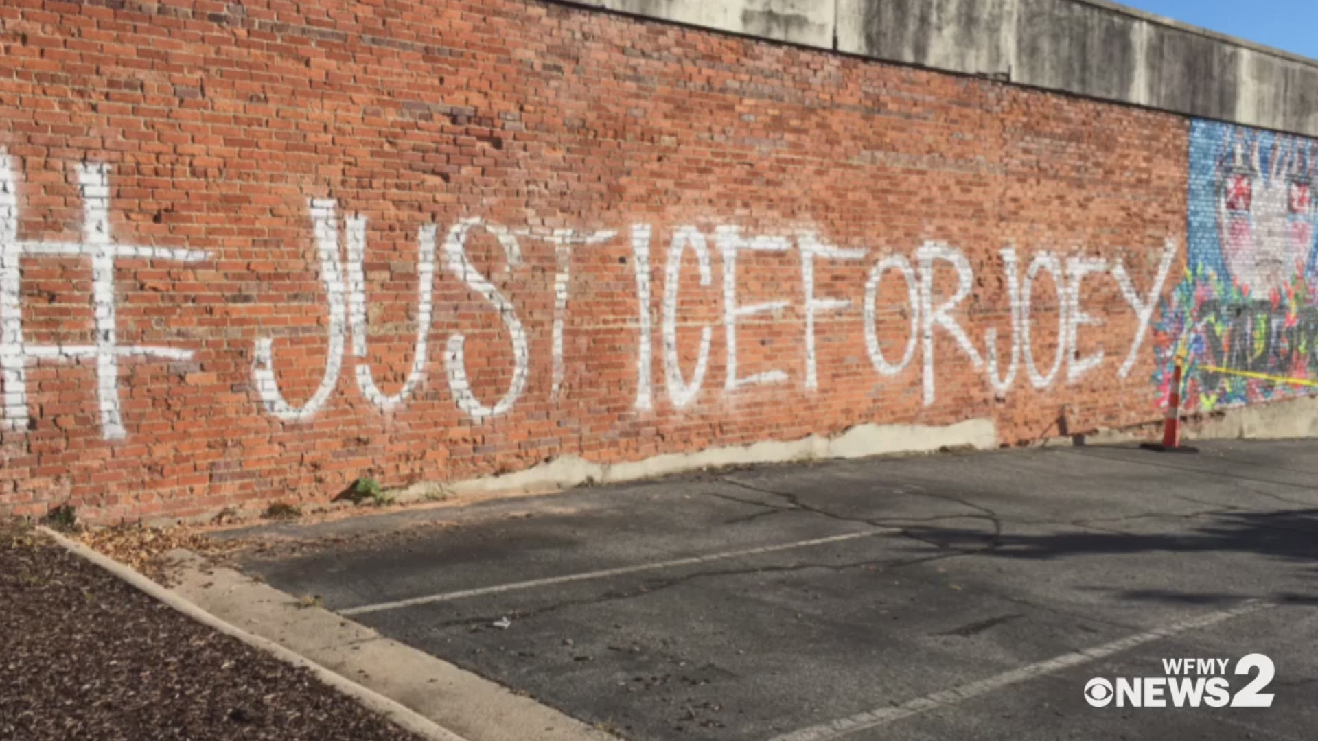 The City of Greensboro has told building owner Marty Kotis the #JusticeForJoey graffiti violates code and needs to be buffed.
