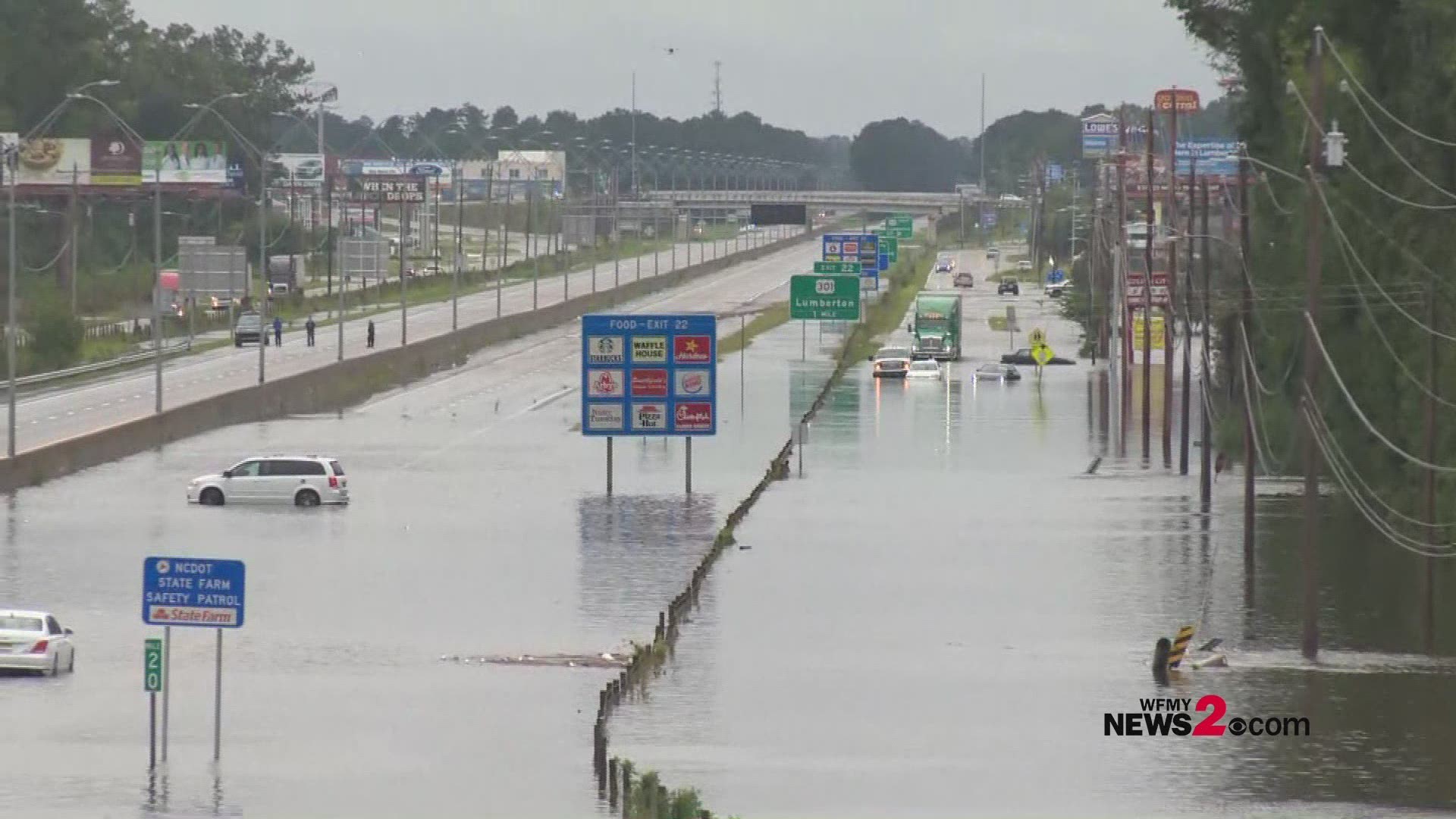 Cars, trucks and 18-wheelers attempt to drive through flooded areas of I-95 in Lumberton.
