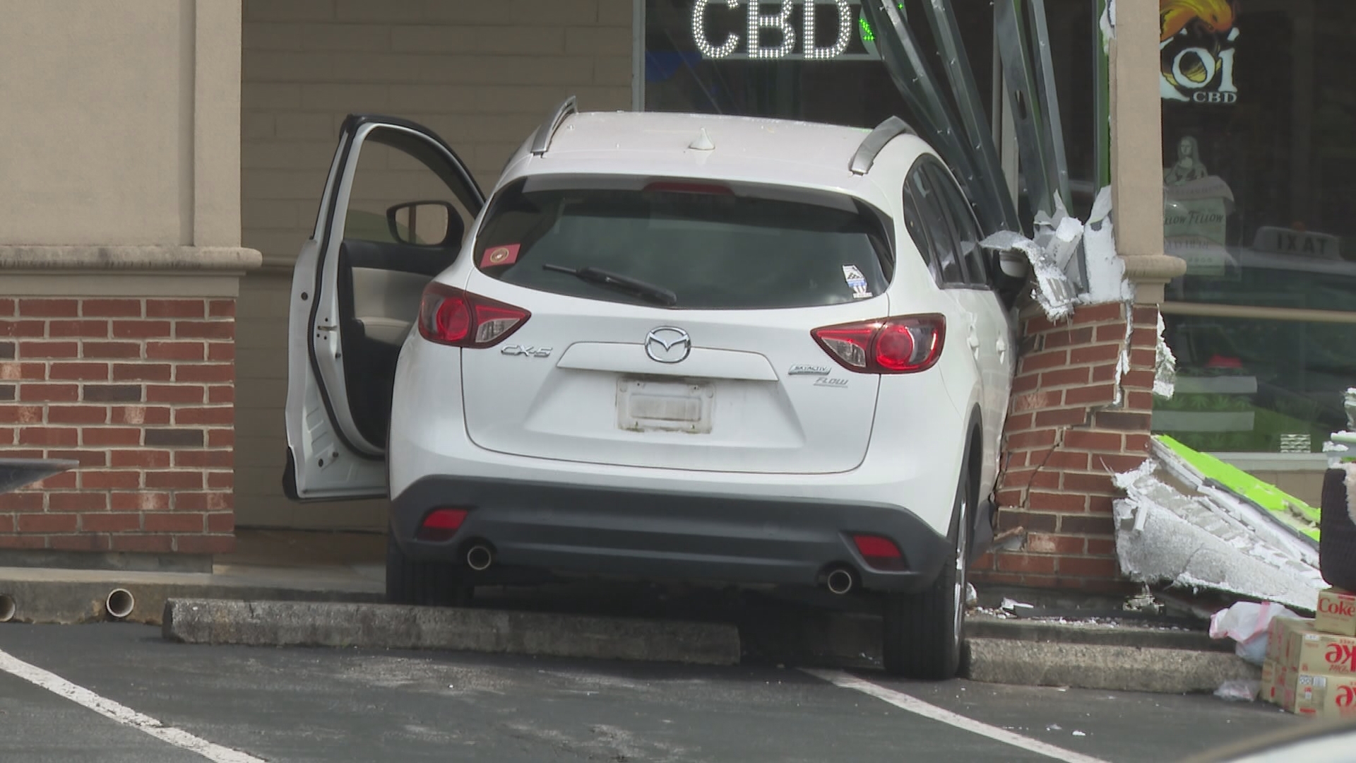 Car crashes into pillar between hemp store and Batteries Plus ...