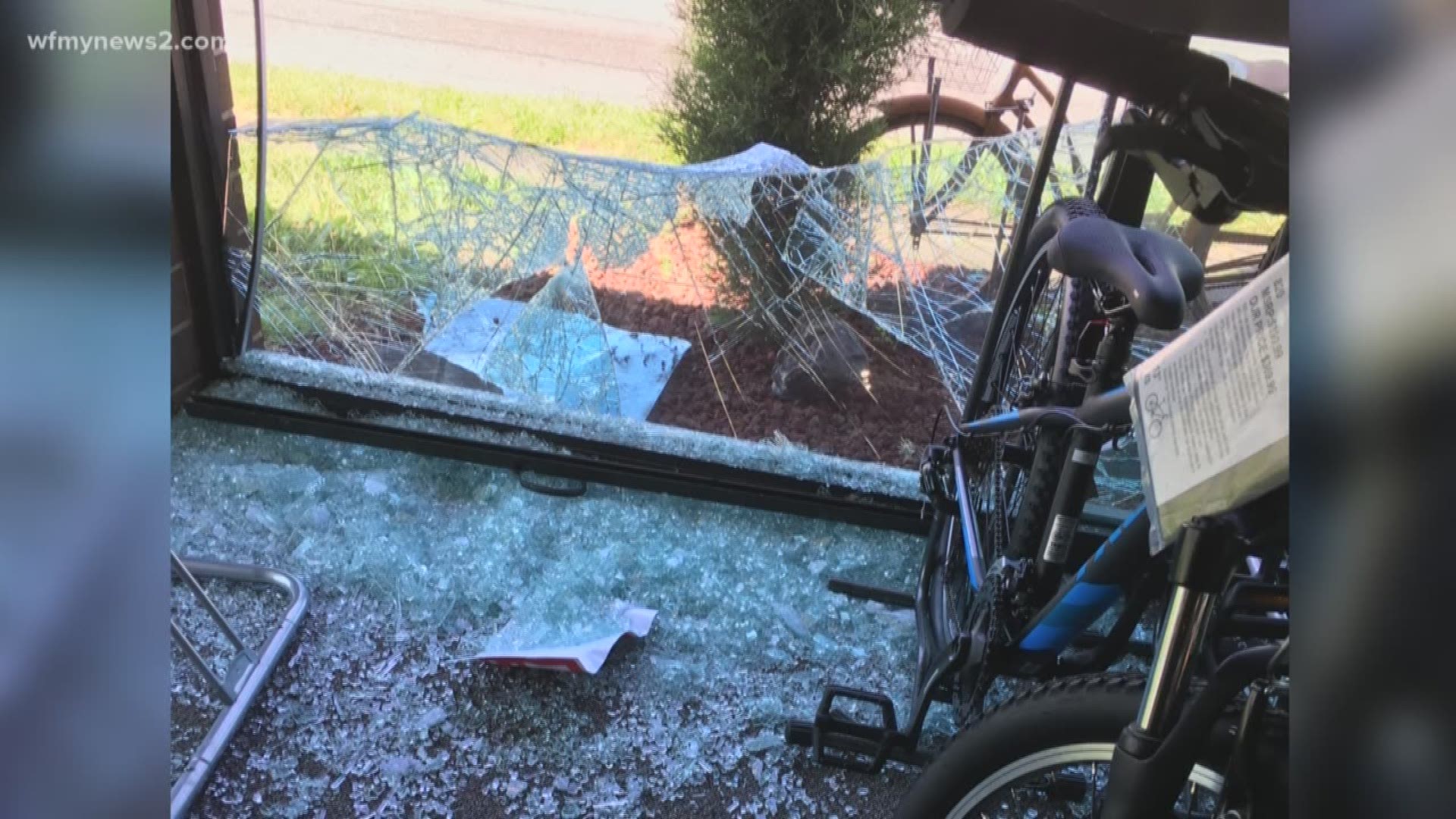 Someone used a huge rock to smash through the glass wall of a popular bike shop in High Point.