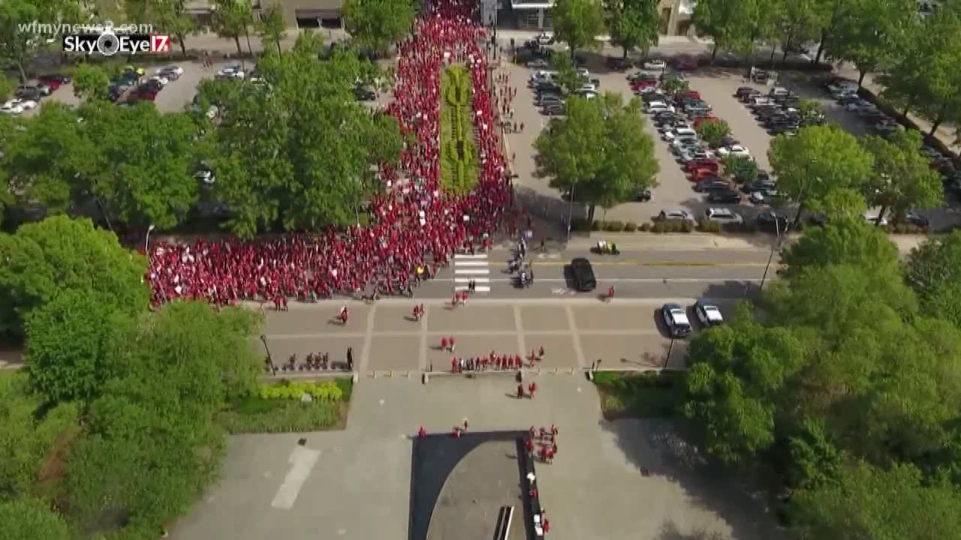 Tens of thousands of educators, dressed in red packed streets in from curb to curb