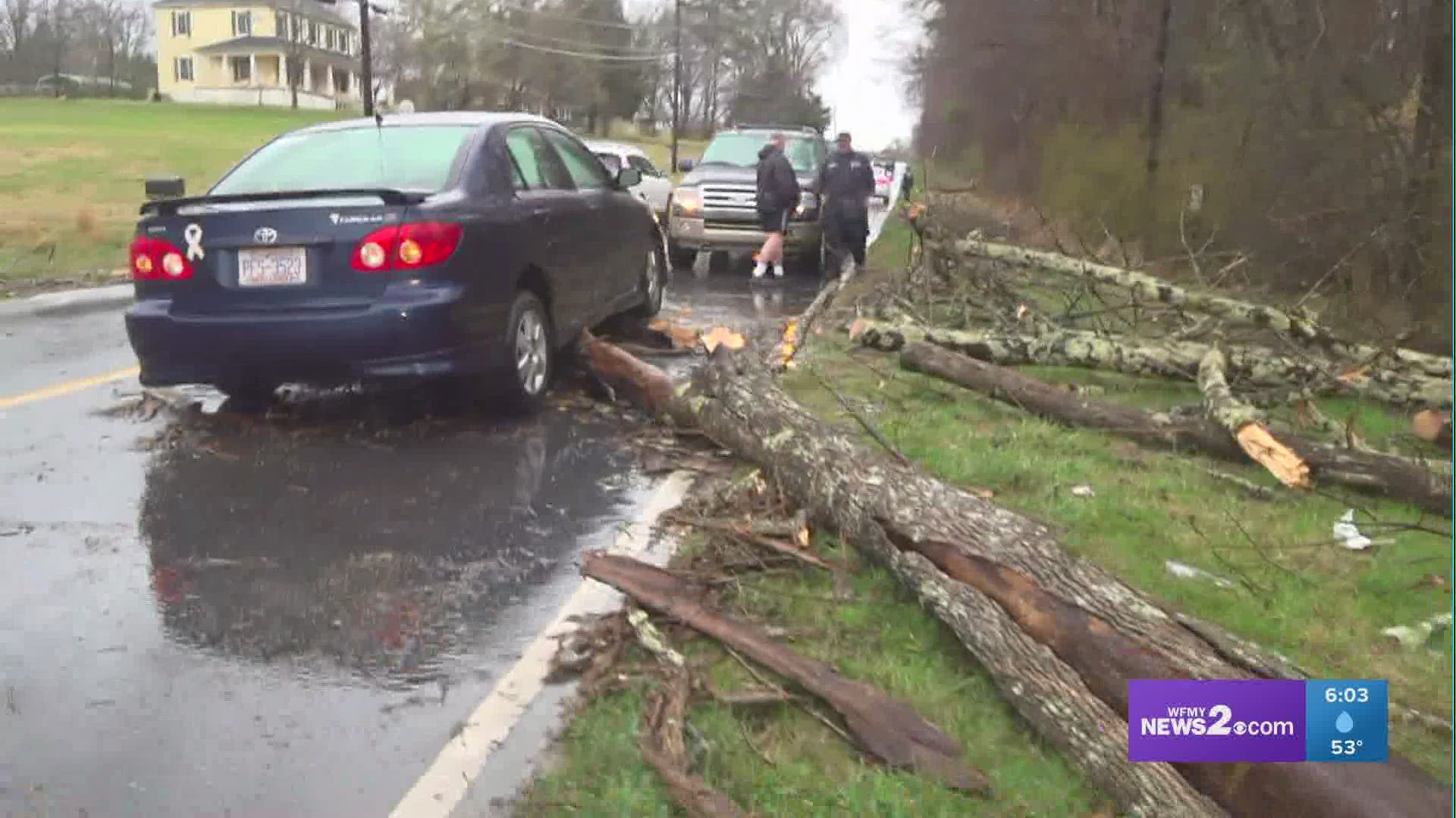 Tree falls in front of a moving car in High Point near Edgemont and Liberty streets as high winds and heavy rain rip through the area on March 18, 2021.