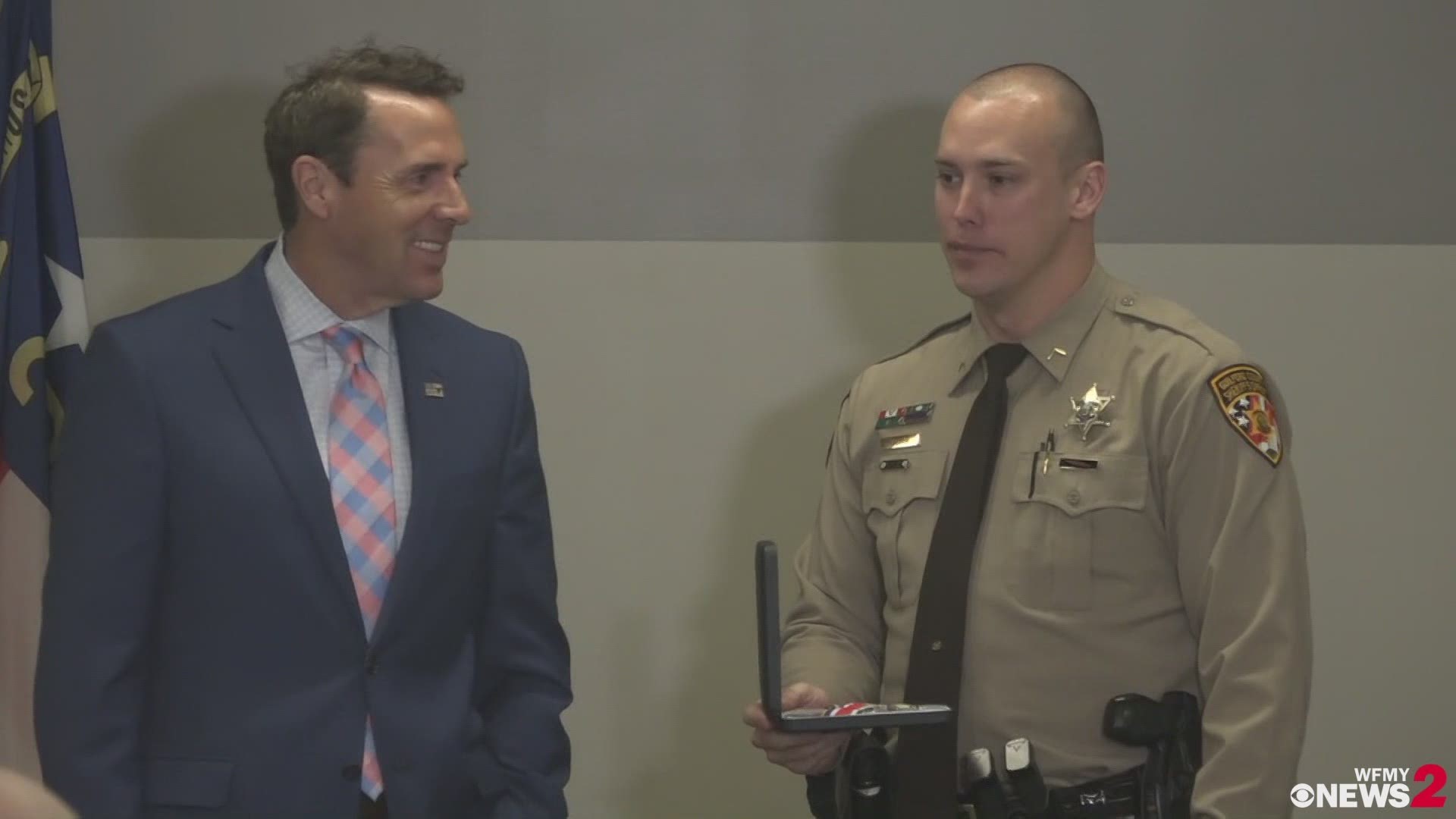 U.S. Rep. Mark Walker presents Guilford County Deputy Matthew Self with the Congressional Badge of Bravery at a service on Monday. Self was shot while on a domestic violence call in 2017.